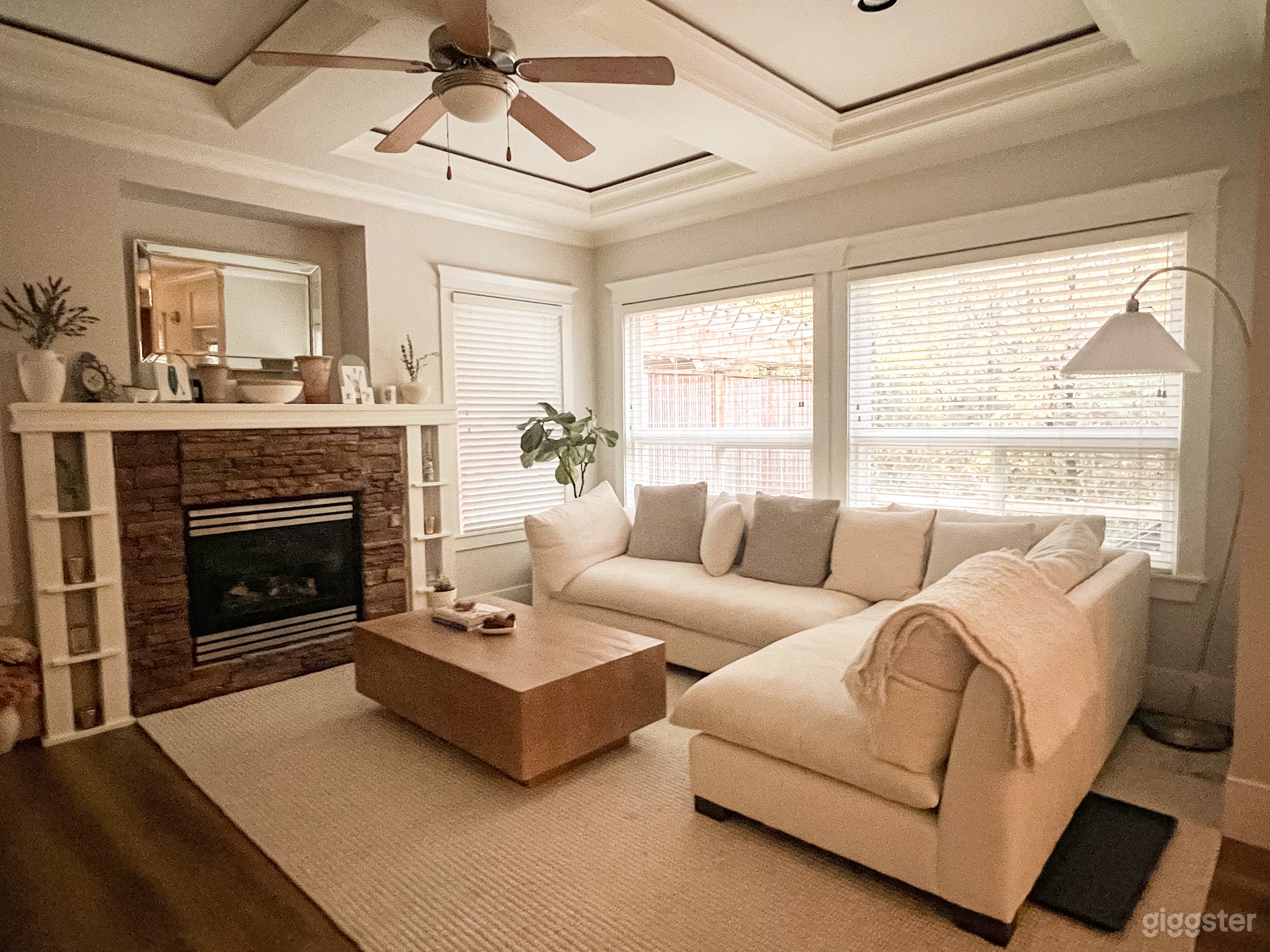 Bright Scandinavian-style living room with a cozy sectional, natural wood accents, and soft neutral tones.