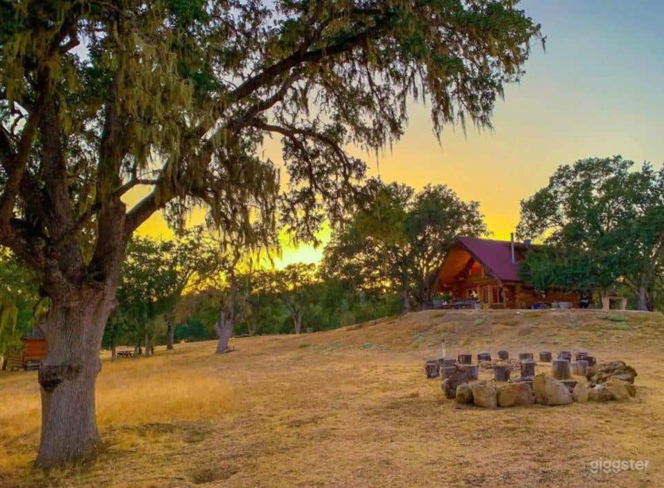 Lookin from Bar Cabin toward main cabin beyond fire Pit. 