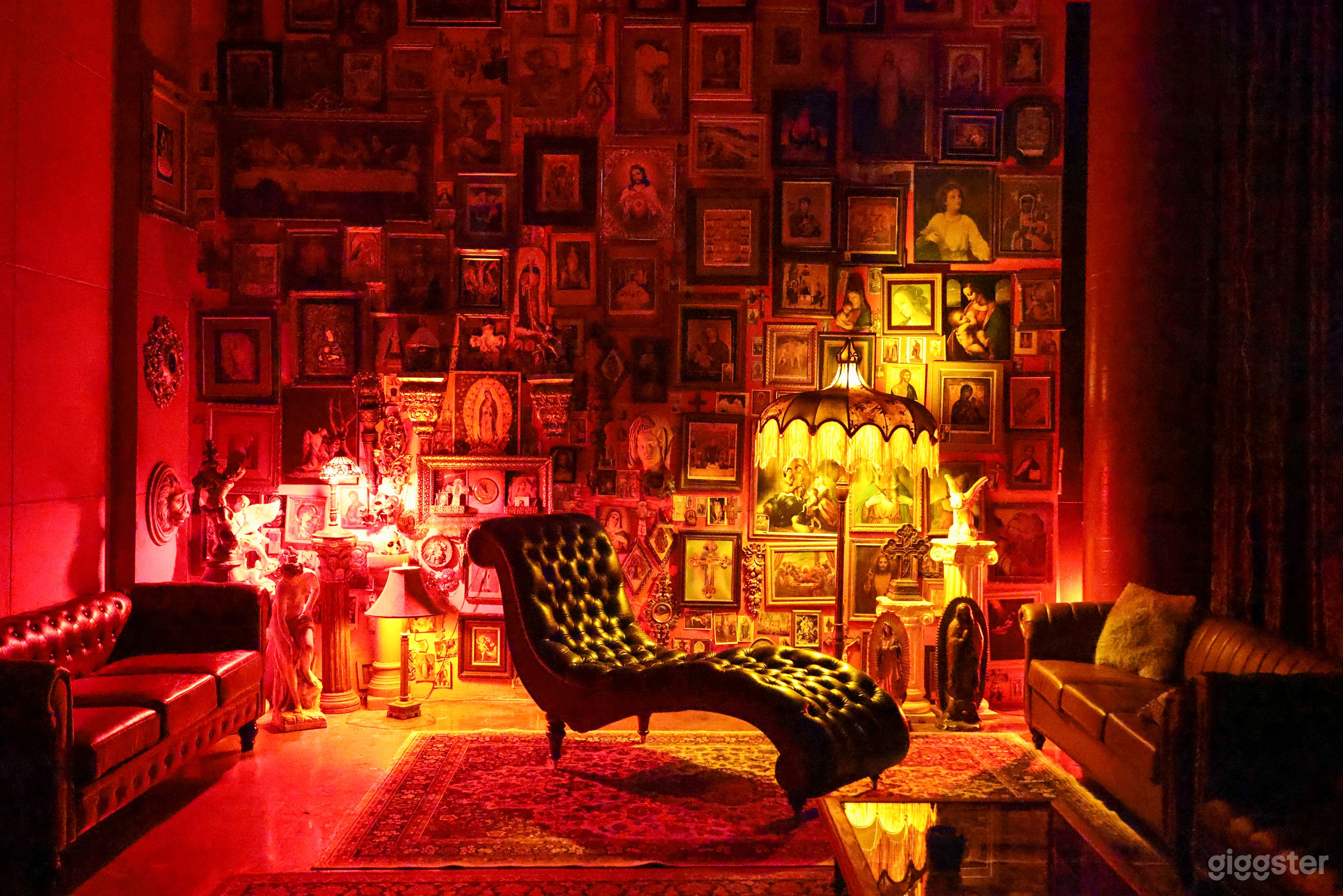 Curvy leather couch in front of the Jesus Wall