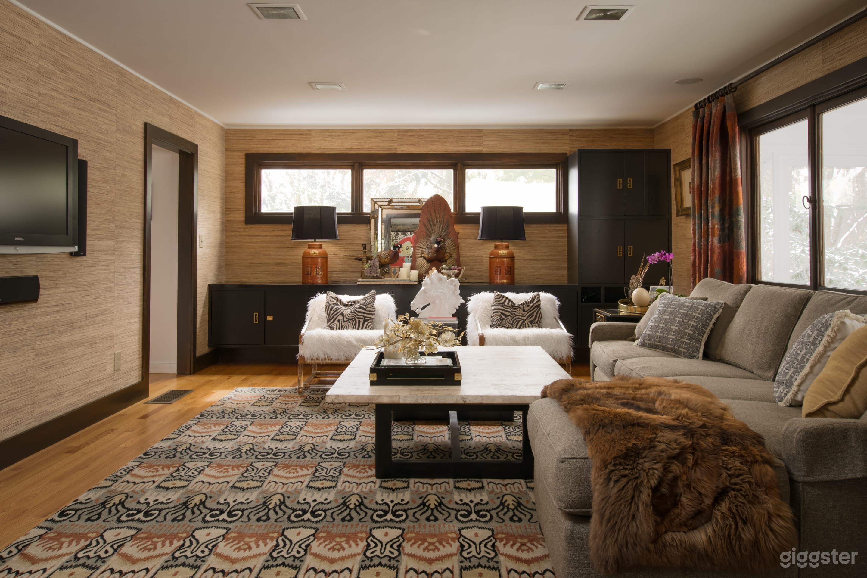 Family room with built-ins and grasscloth wallpaper