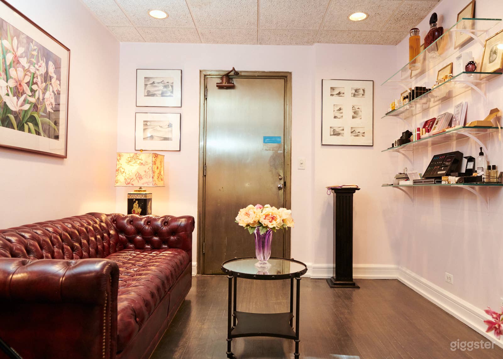 View of the "waiting room" with Chesterfield sofa - not shown in this pic is the mottled pink rug and marble side table under the bookshelf