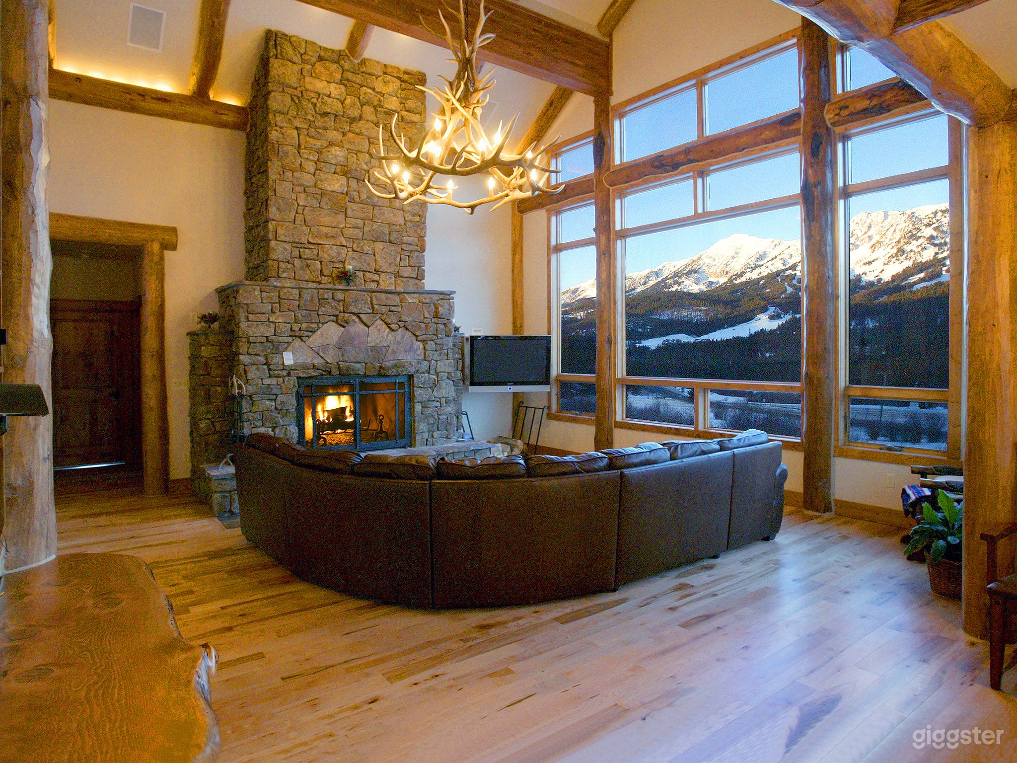 extra large wood burning fireplace with view of ski slopes at Bridger Bowl