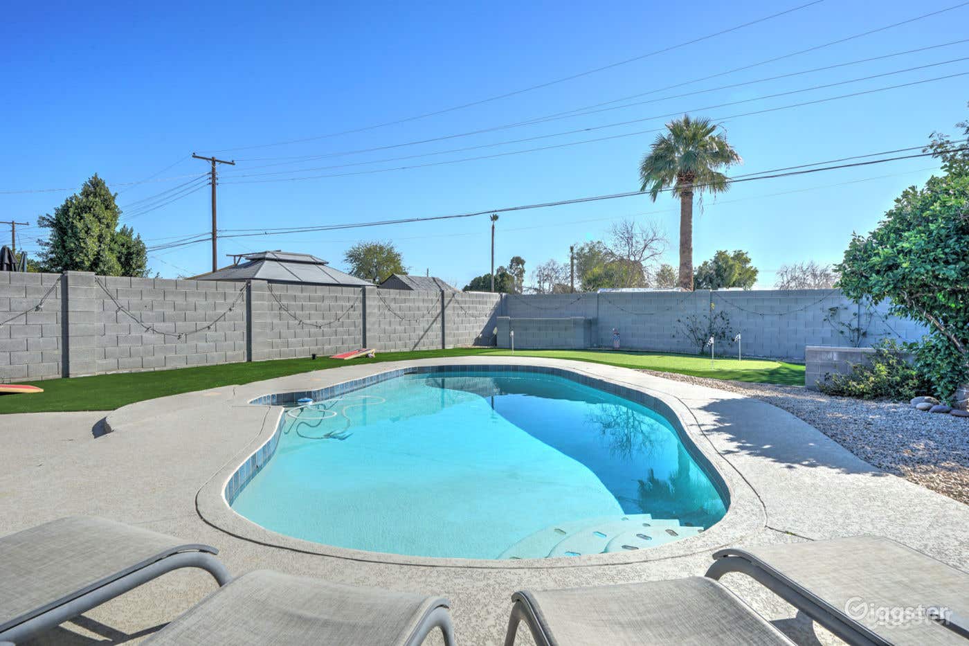 Bright Pool Area with Beautiful Backyard Photo 3