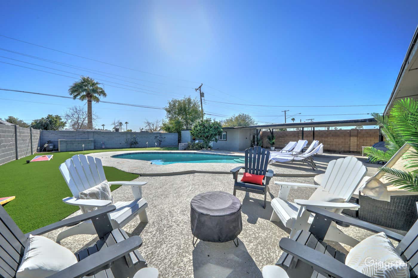 Bright Pool Area with Beautiful Backyard Photo 1