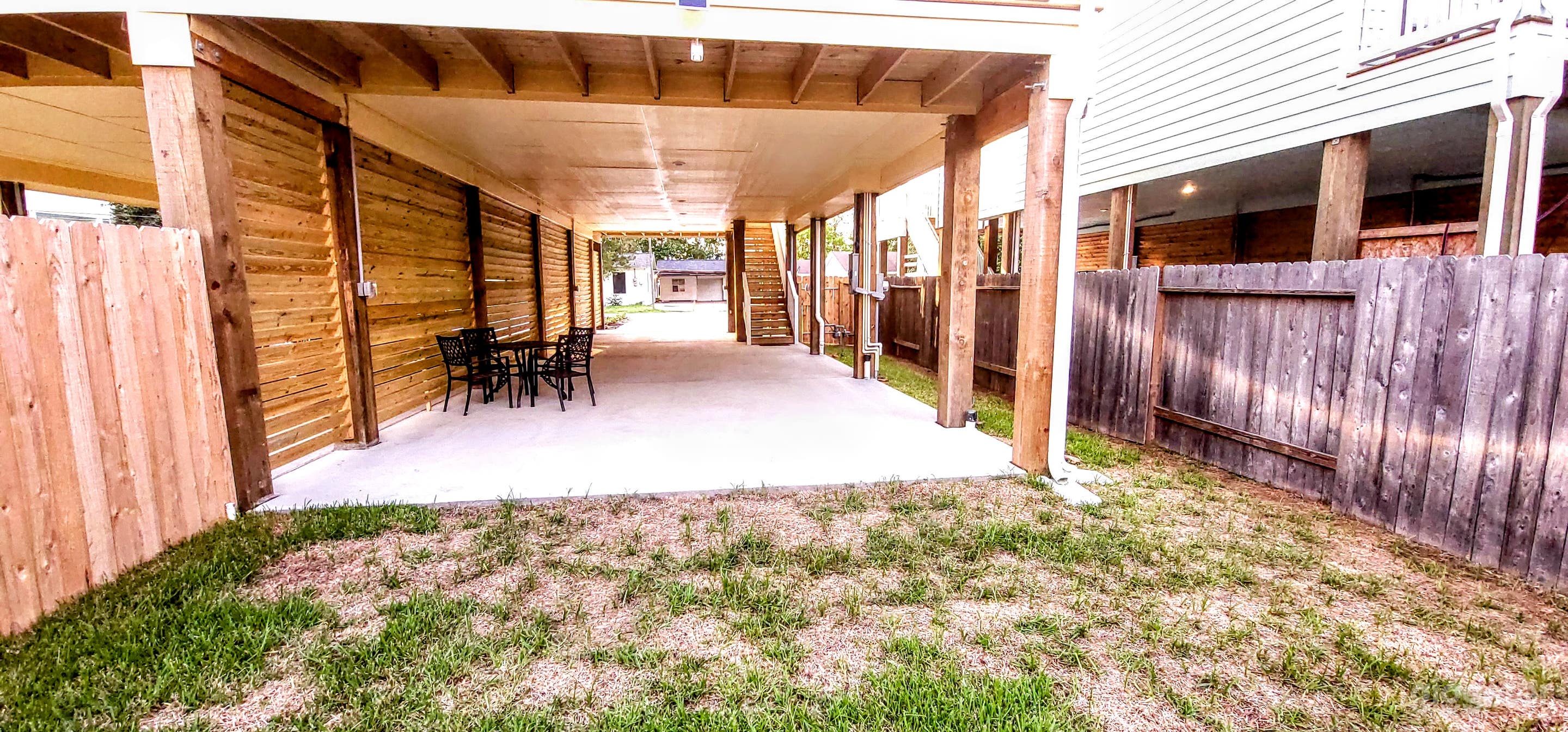 Rear view of carport with access to backyard