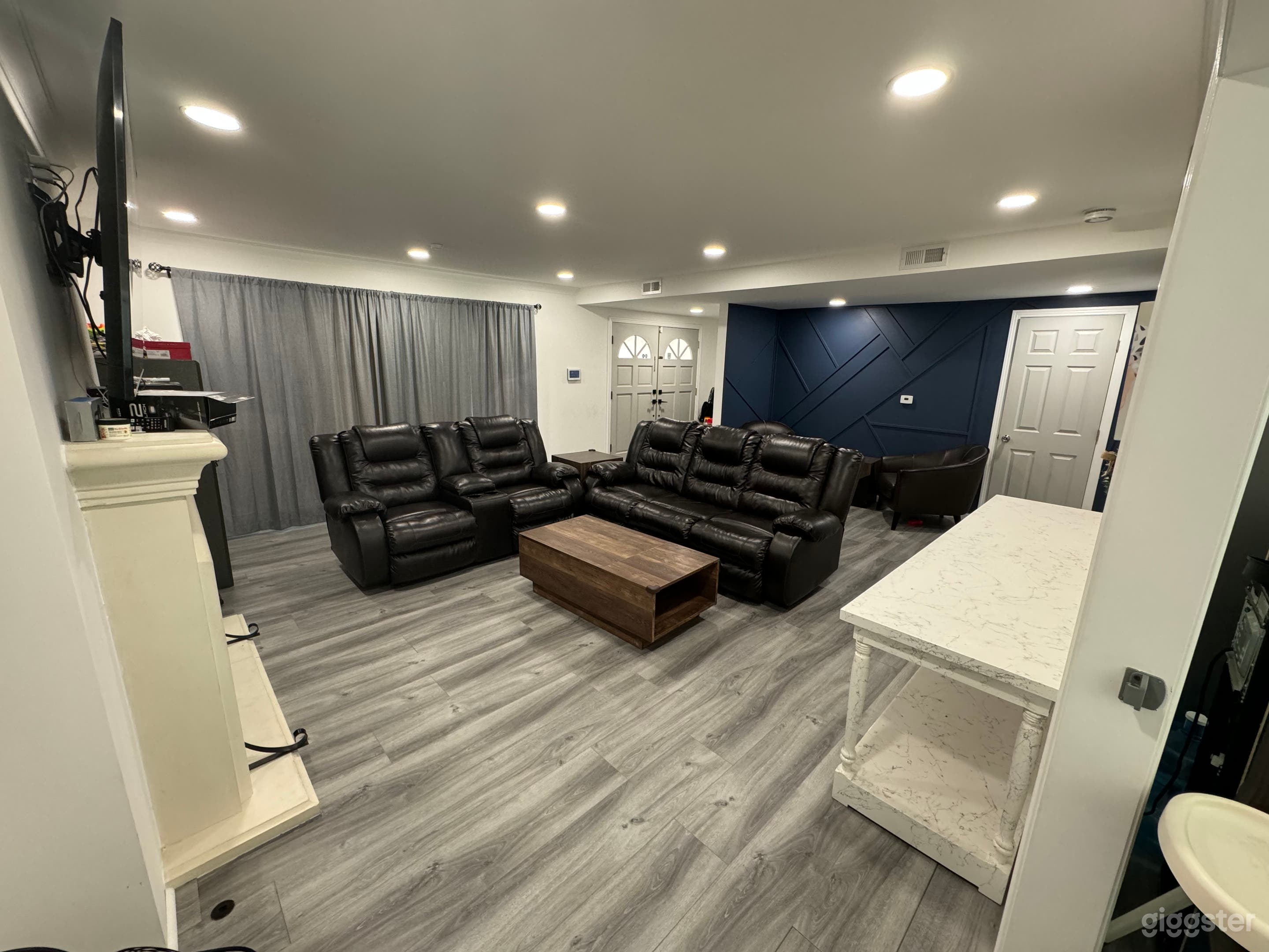 Living room area looking towards front entry. central cooling can be used at all times if filming.