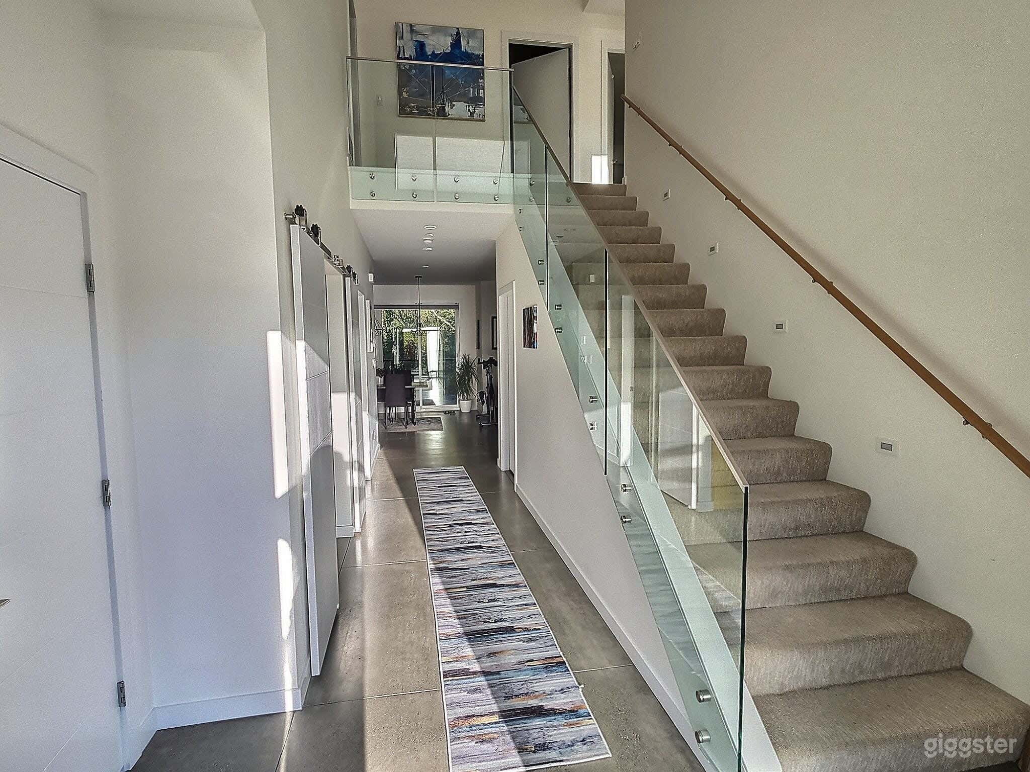 Entering through the front door, you'll be met with this modern spacious entrance hallway. All 4 bedrooms are located upstairs with 2 bathrooms.  Downstairs is the kitchen dining, living area with 1/2 bathroom, workspace &amp; access to the garage