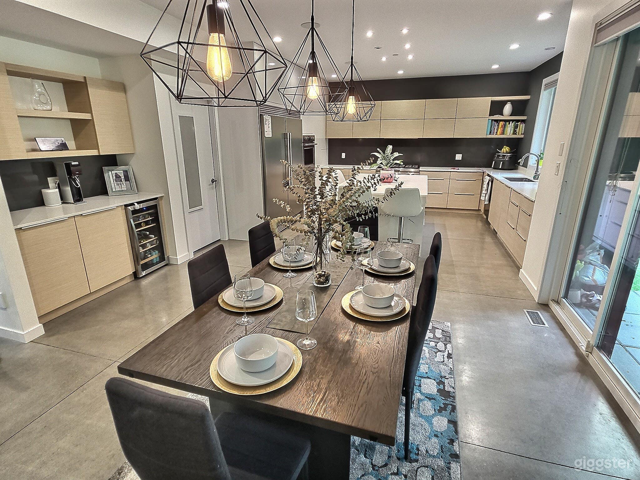 Dine on our 8 person dining table, next to ceiling to floor windows and doors, overlooking the patio, backyard and forest.
Enjoy a drink a the bar, consisting of wine/beer fridge 