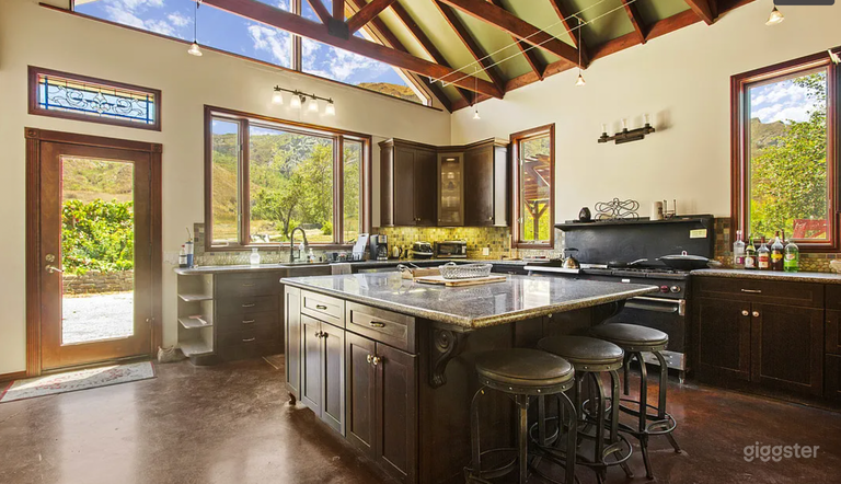  View of the kitchen island, commercial oven in background 