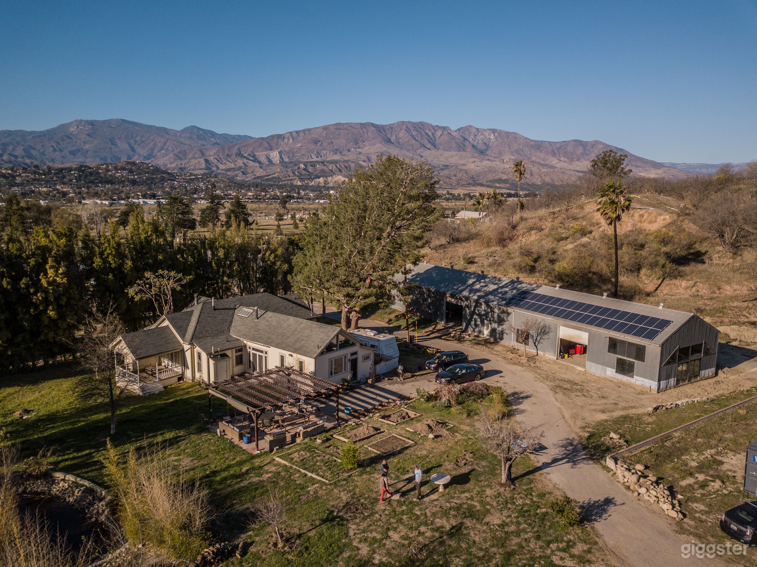 An aerial of the house, kitchen garden, and metal hangar
