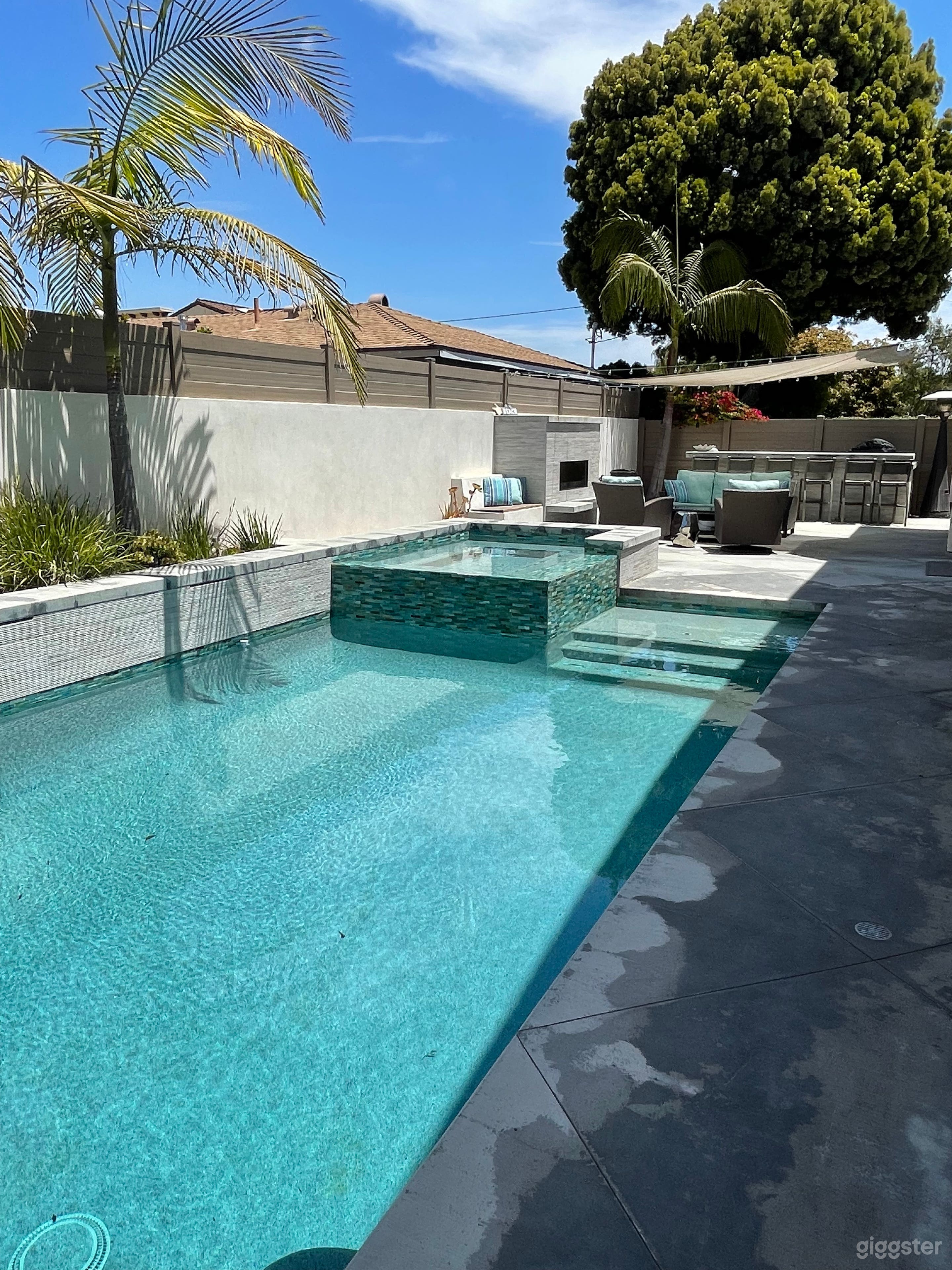 Pool and spa with water feature and LED color lights.
Fireplace and large BBQ area.