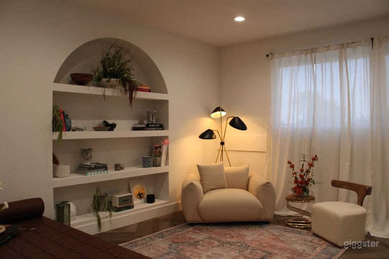  STUDIO B: An apartment studio located on the second floor, featuring herringbone dark wood flooring, in-set arched bookcase, vintage and designer furniture and decor 