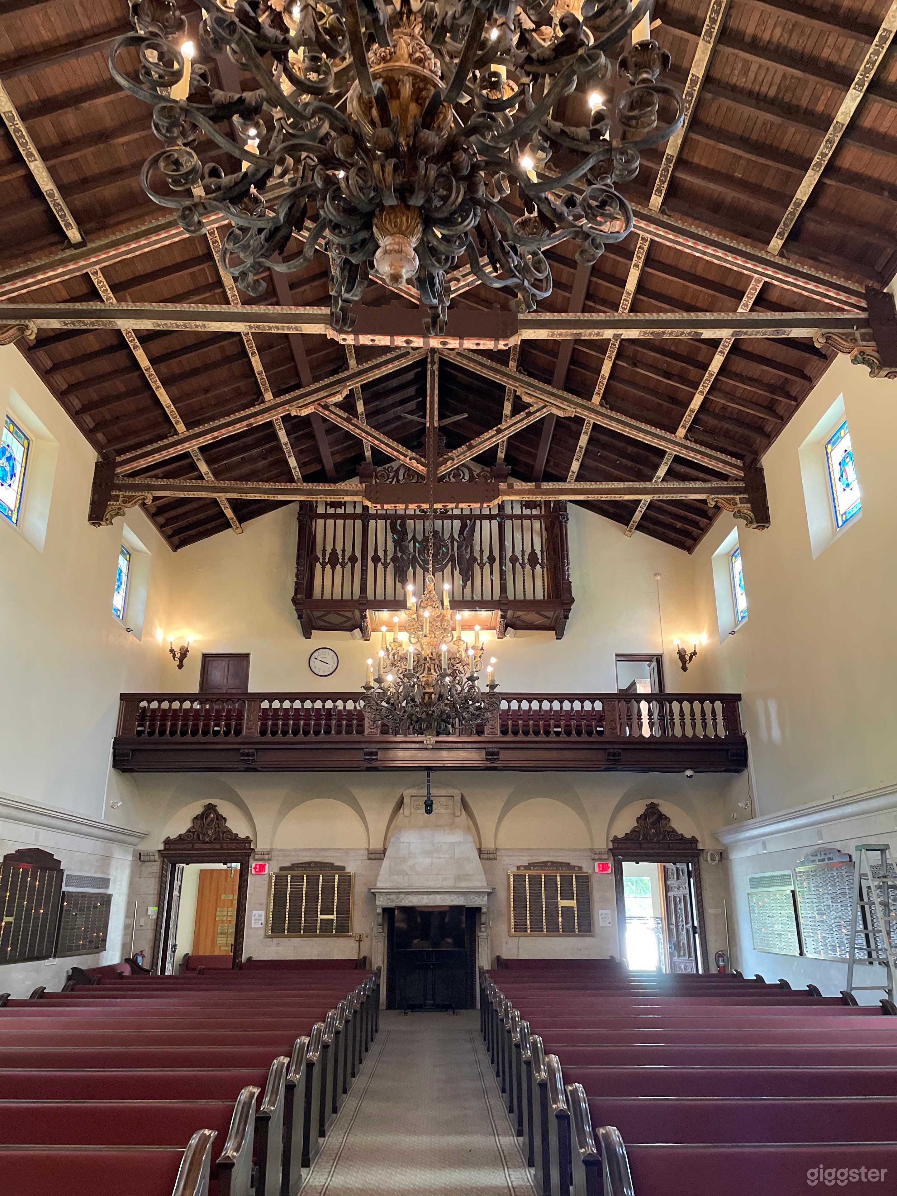 Music conservatory with stained glass windows, detailed ceiling, podium, seating for 300.