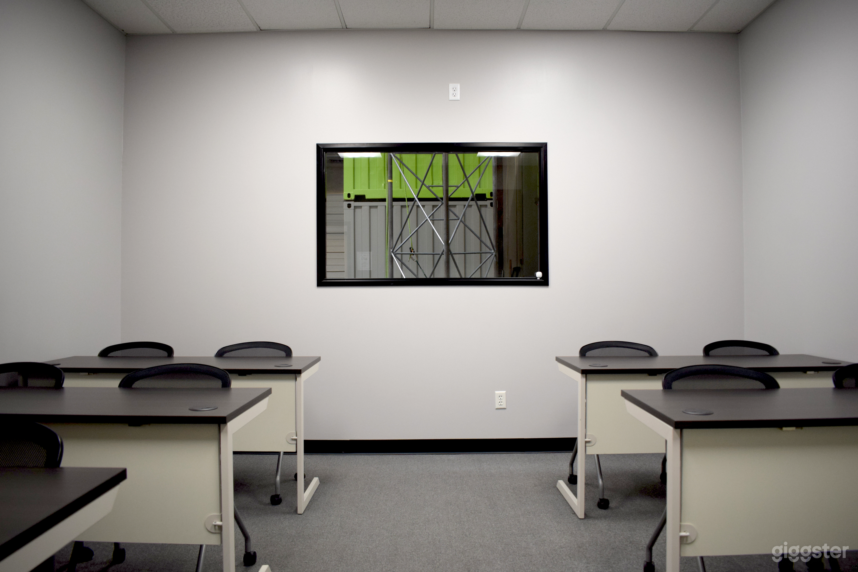 Our 12 person capacity classroom. Now featuring a small TV above the window for the presenters view of your slideshow.