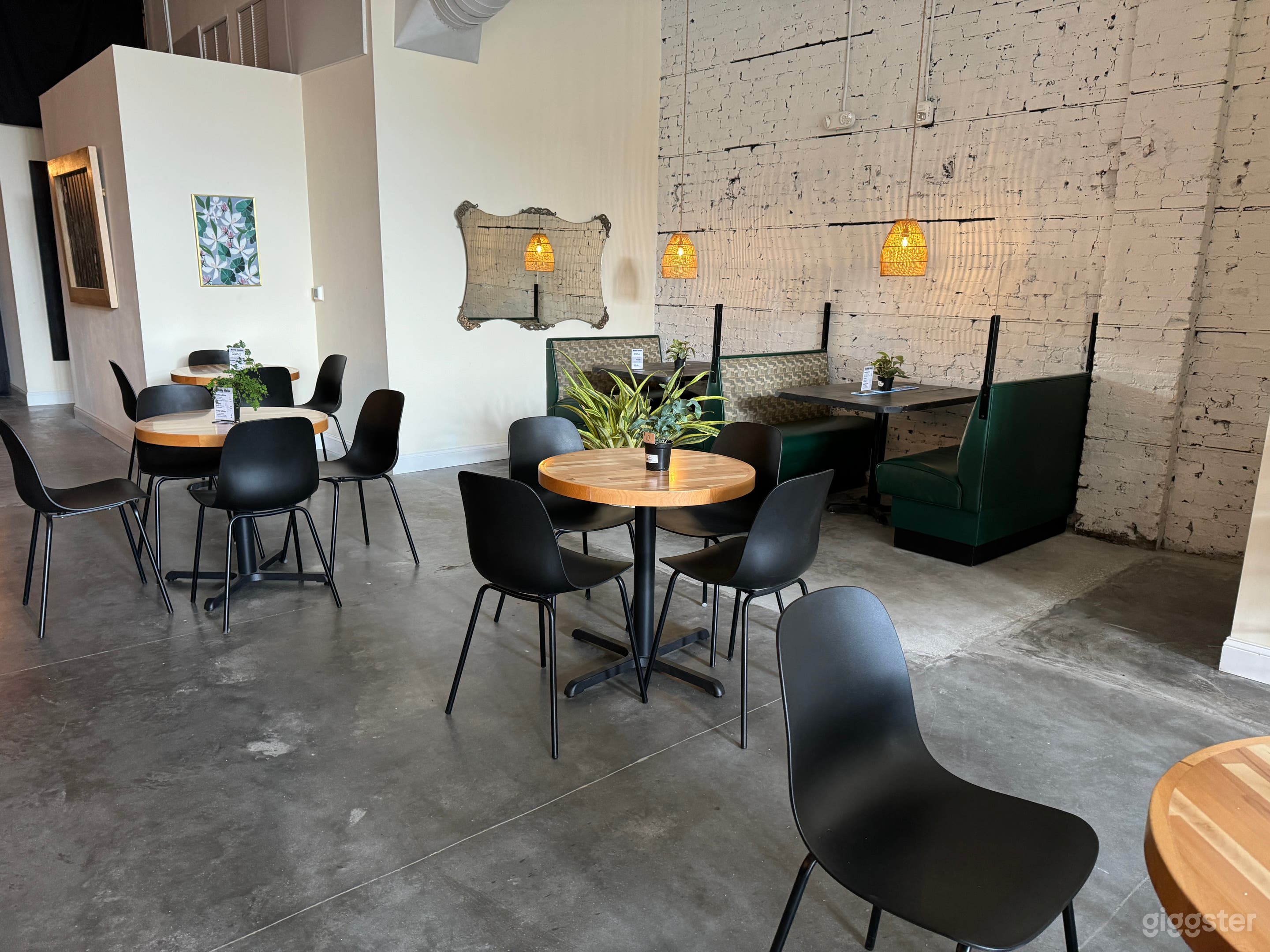 Booth detail looking toward back of restaurant with white brick wall