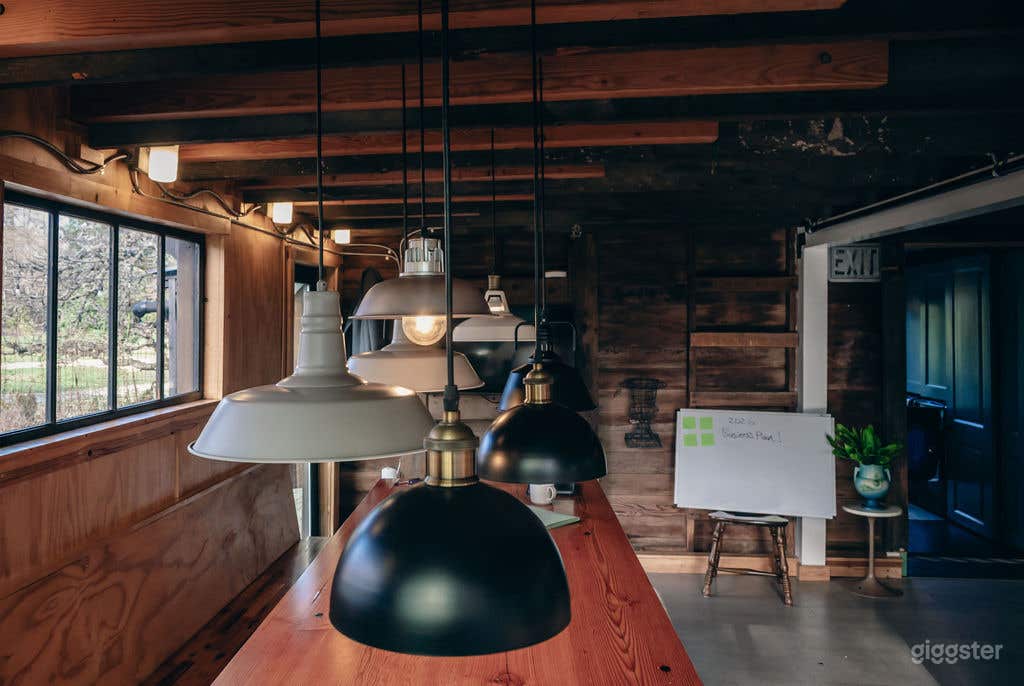 The Barn's main community dining area. Features warm wood textures and industrial-chic lighting, ideal for lifestyle scenes or production meetings.