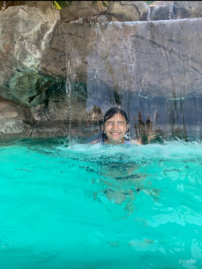  There’s a grotto with a bench seat under the waterfall. 