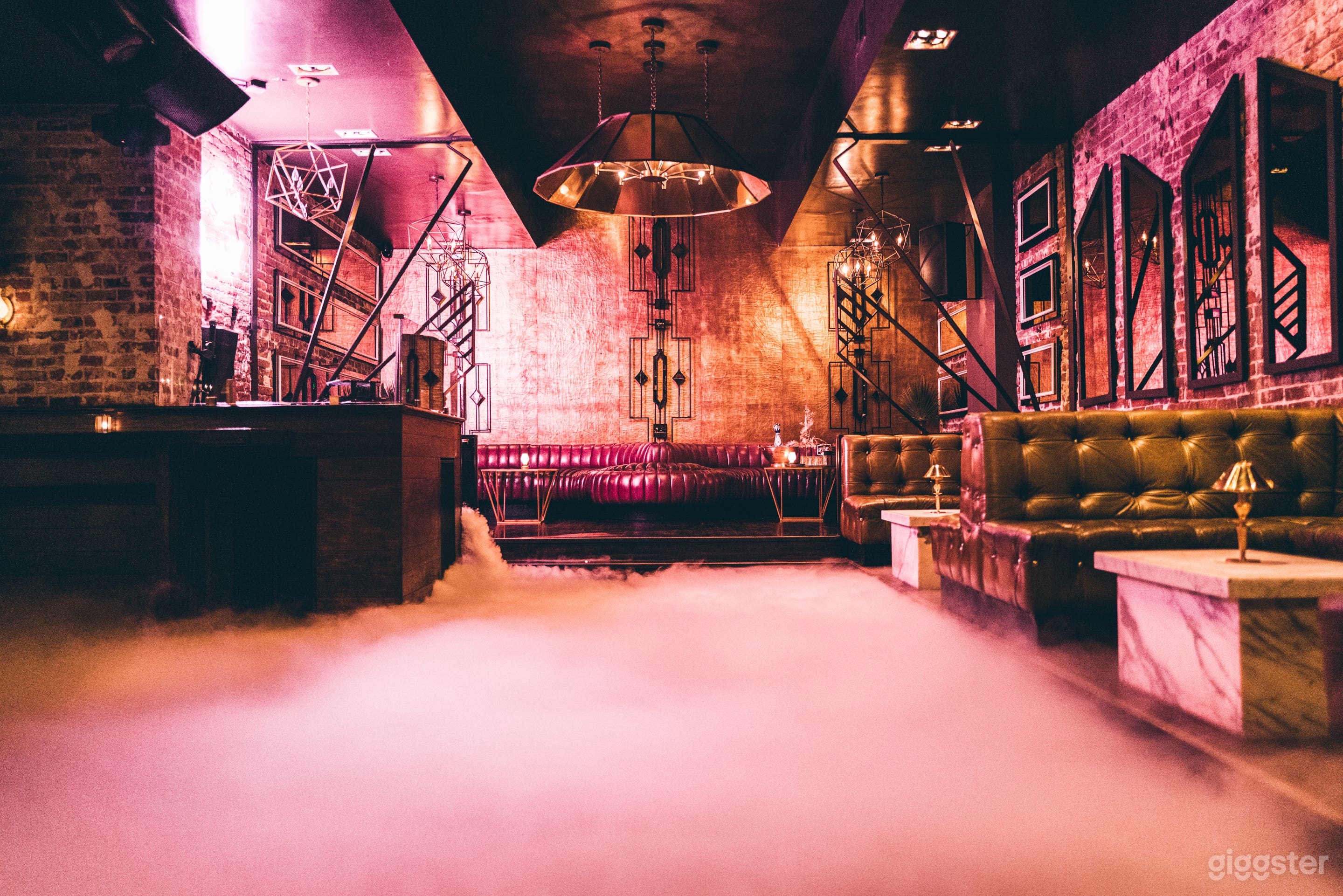 Main dance floor / networking space of the venue. Channel Tufted Pink leather Banquette seating in back is Called the W Booth. On the right are the cortina leather Mossy Olive booths. Dancing on Clouds experience was activated for this photo.