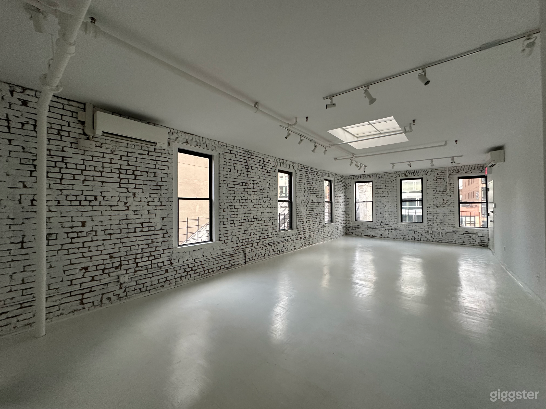 Artistic All-White Loft with Walls of Windows Photo 1
