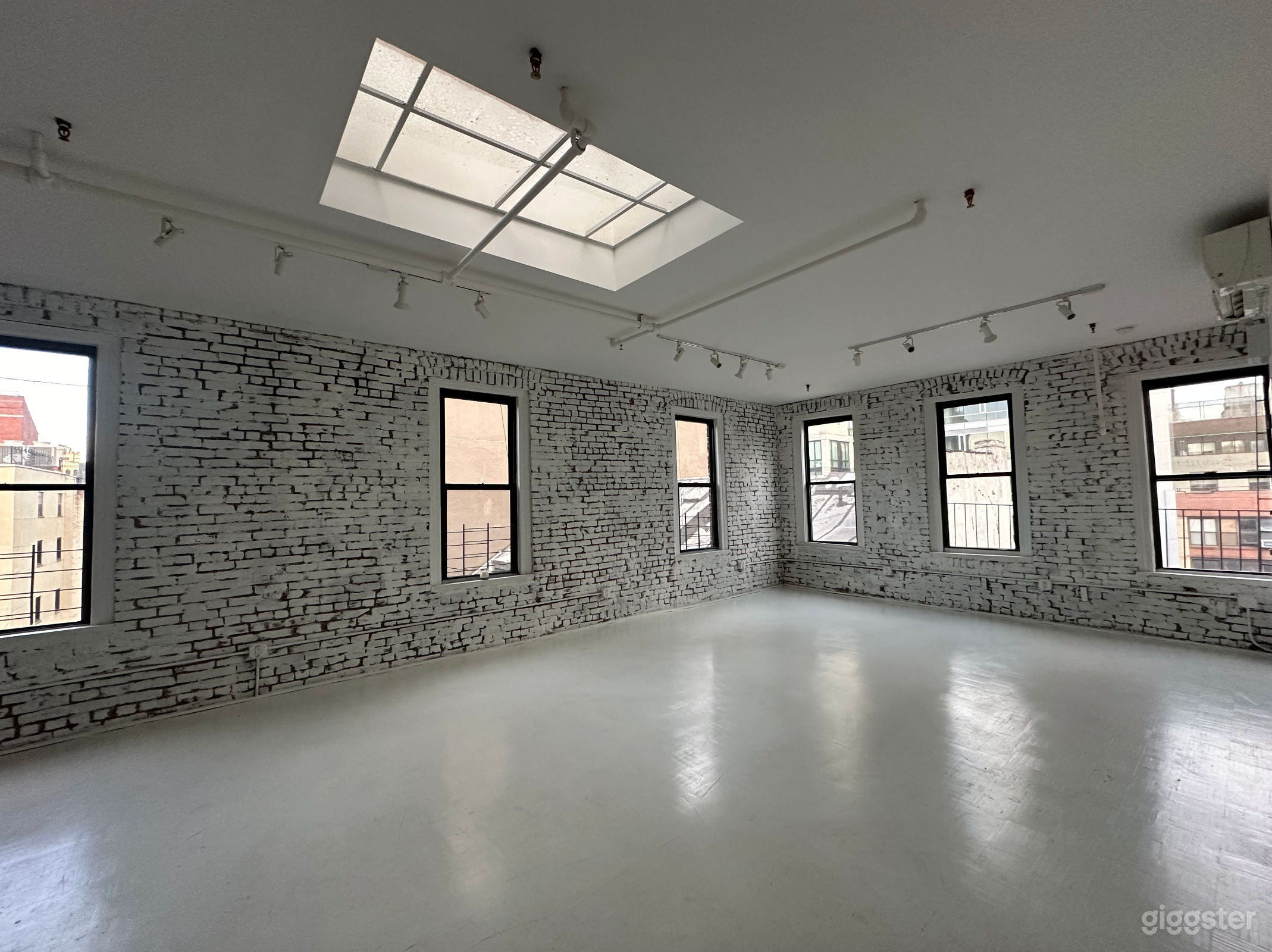 Artistic All-White Loft with Walls of Windows Photo 2