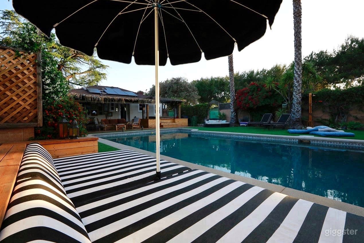 The Lounge! Giant black and white striped cushions and pagoda umbrella edge up tot he pool.