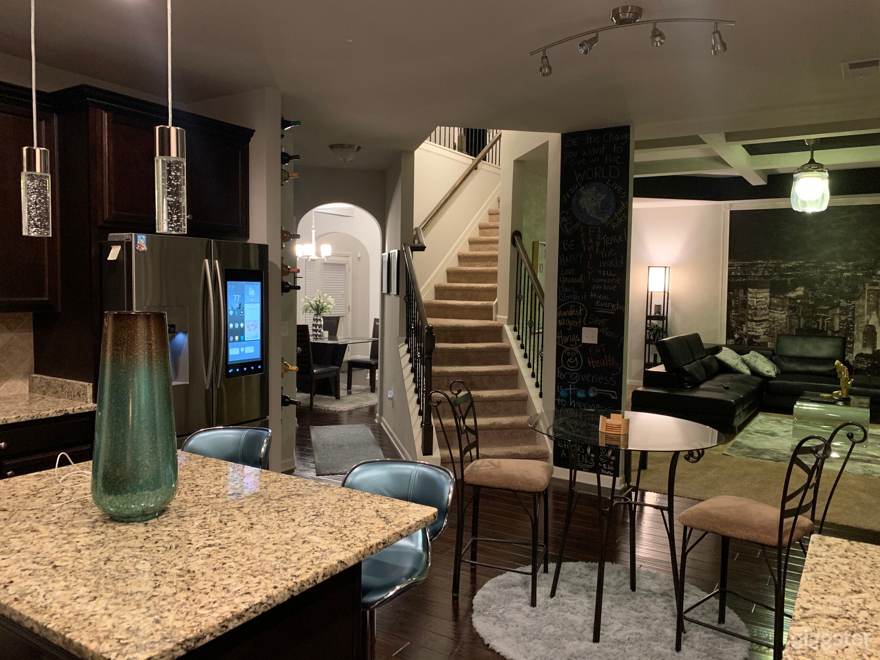 View from kitchen with partial view of dining room through mud area. View of steps leading to upstairs and partial view of family room.