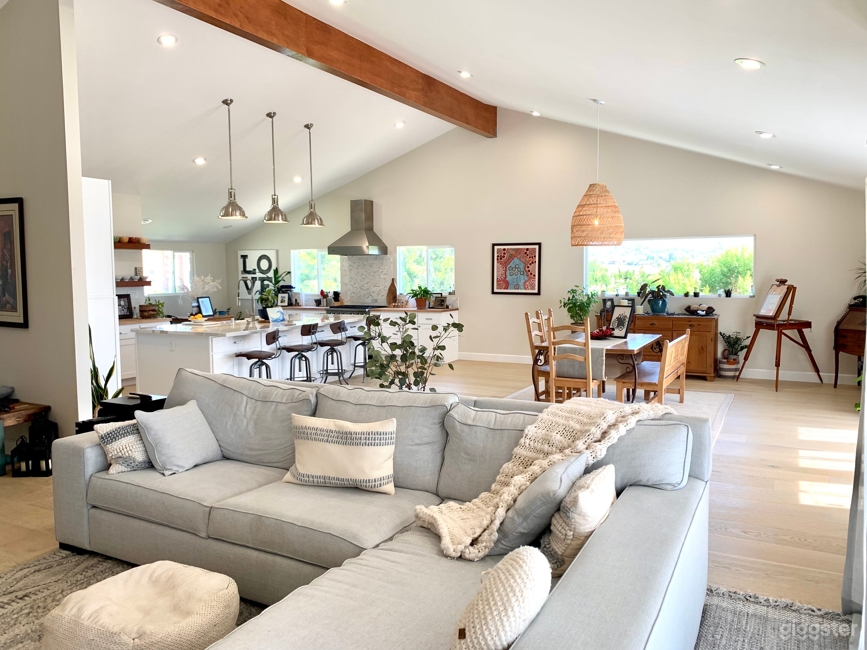 The massive great room spans over 1,500 square feet and includes an entertainers kitchen, a large dining space, and an open concept living area.