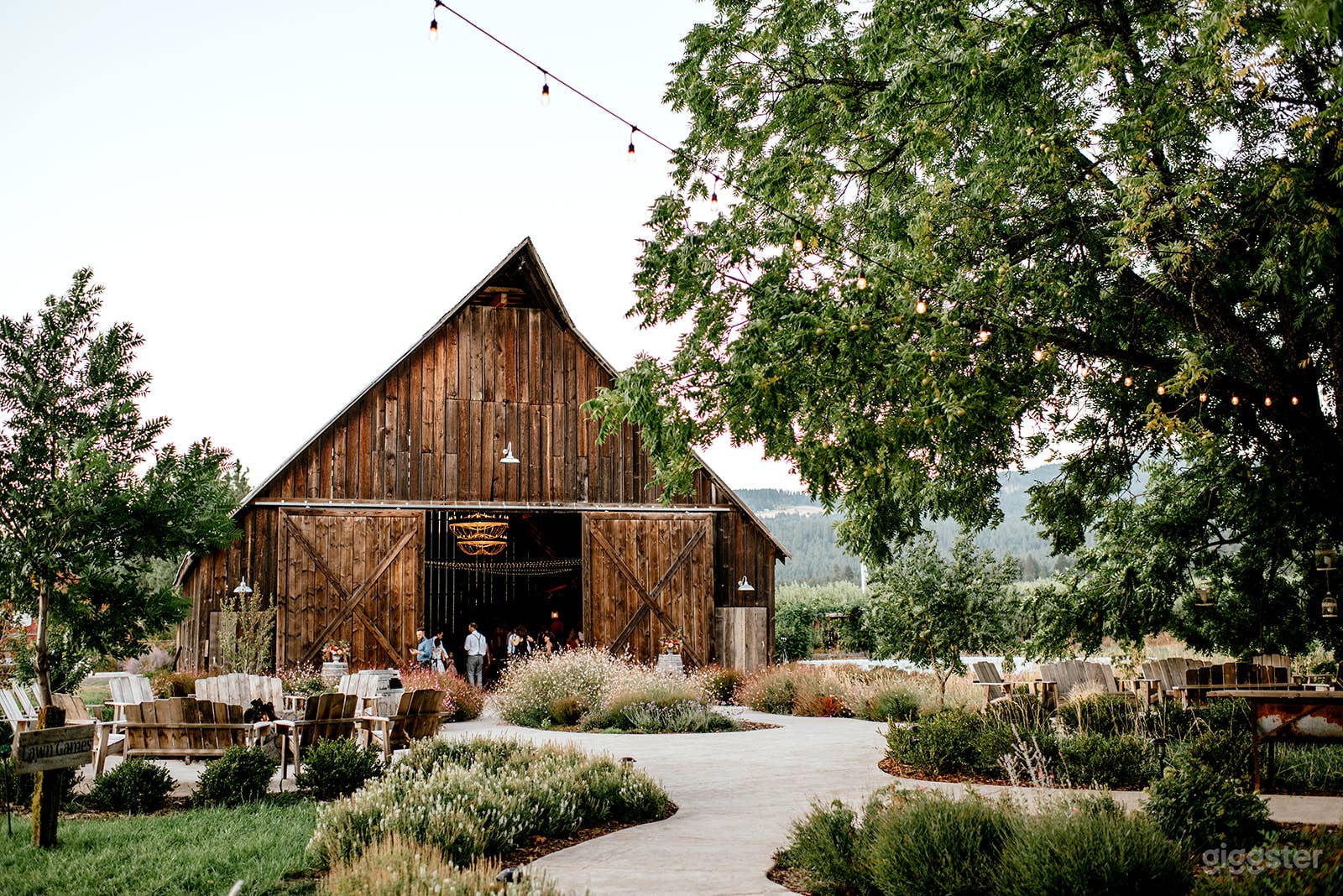 Barn and courtyard (fire pit to left, additional seating area to right under tree)
