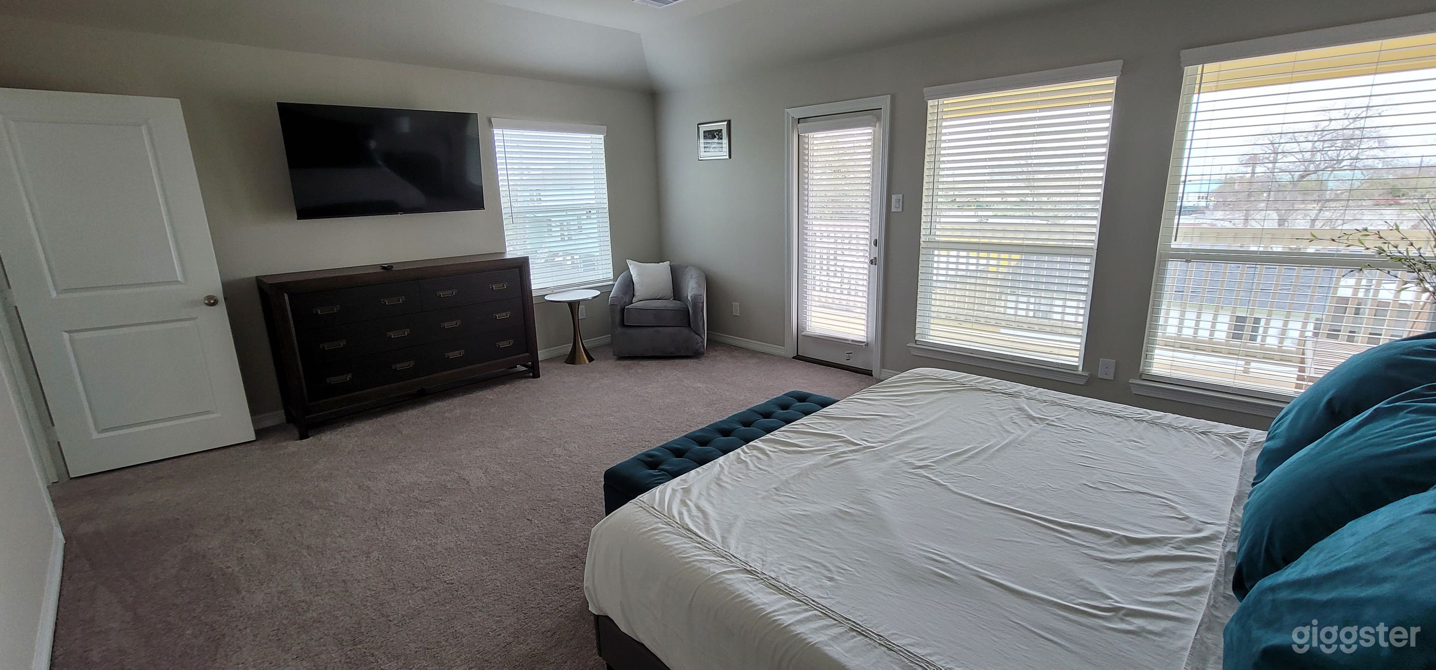 Primary bedroom upstairs with front balcony