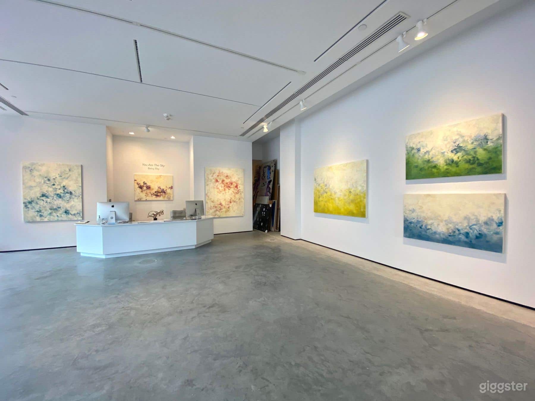 View of front desk, entryway to kitchen &amp; bath, and back wall