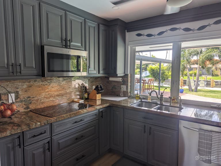  Kitchen stove/sink overlooking backyard 