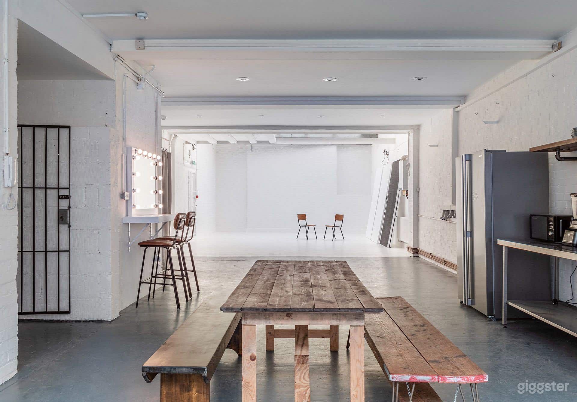 Bright White-Brick Warehouse Studio with Industrial Kitchen &amp; Backdrops Photo 2
