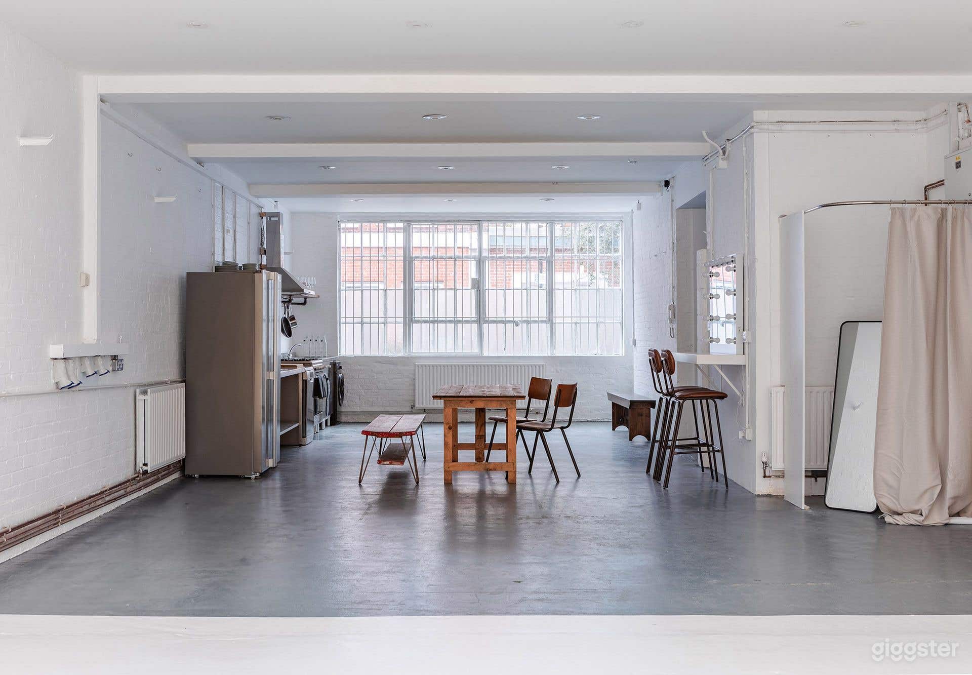 Bright White-Brick Warehouse Studio with Industrial Kitchen &amp; Backdrops Photo 1