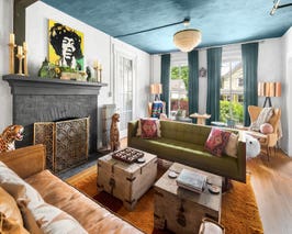  Parlor off the entryway with lounge area, chess table and arm chairs, record player and beanbag chairs, gas fireplace  