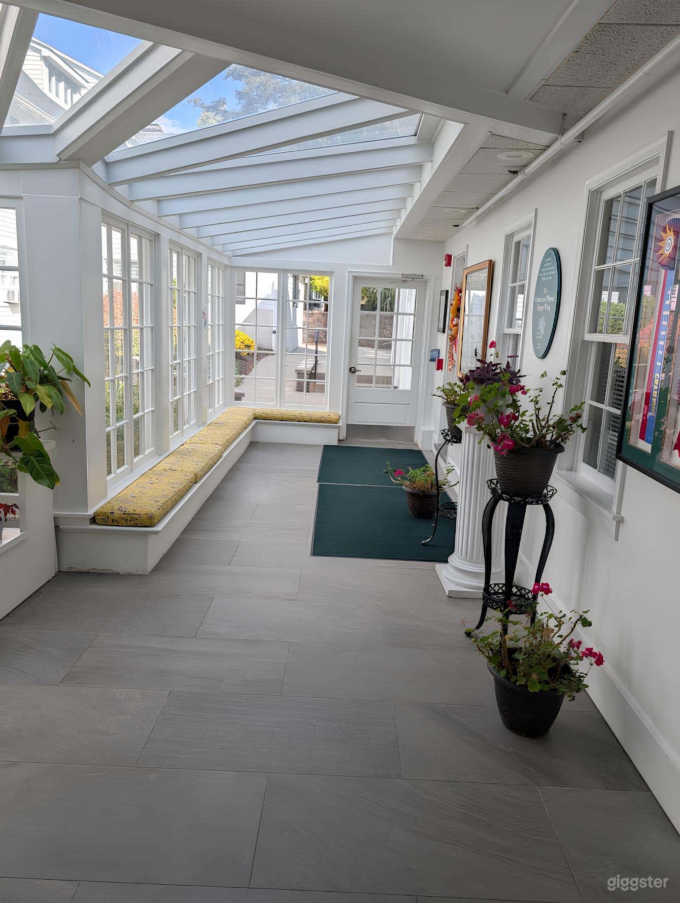 Bright Conservatory with Skylights & Lush Greenery Photo 3