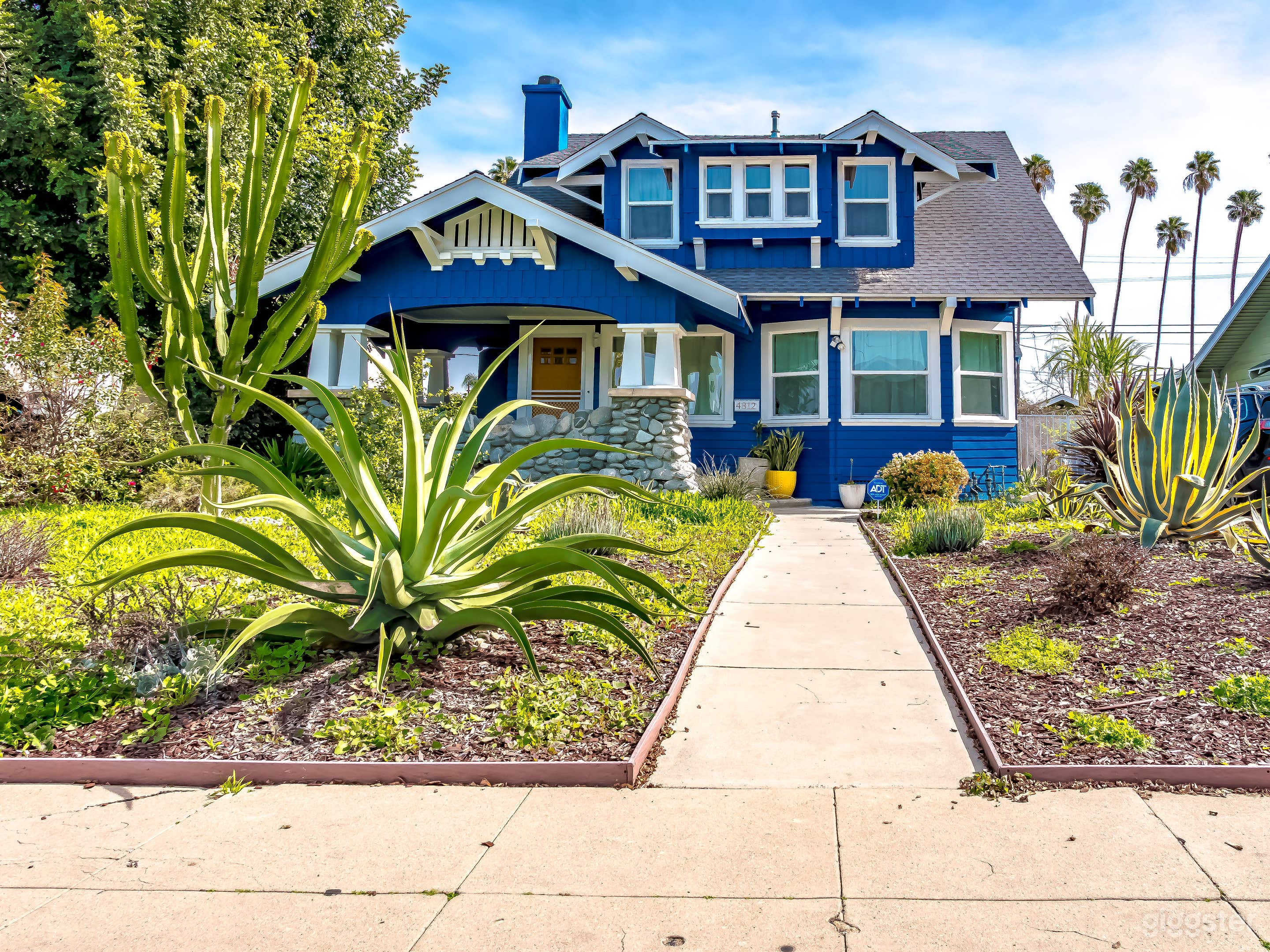 Large front porch; front yard features gorgeous succulent plants