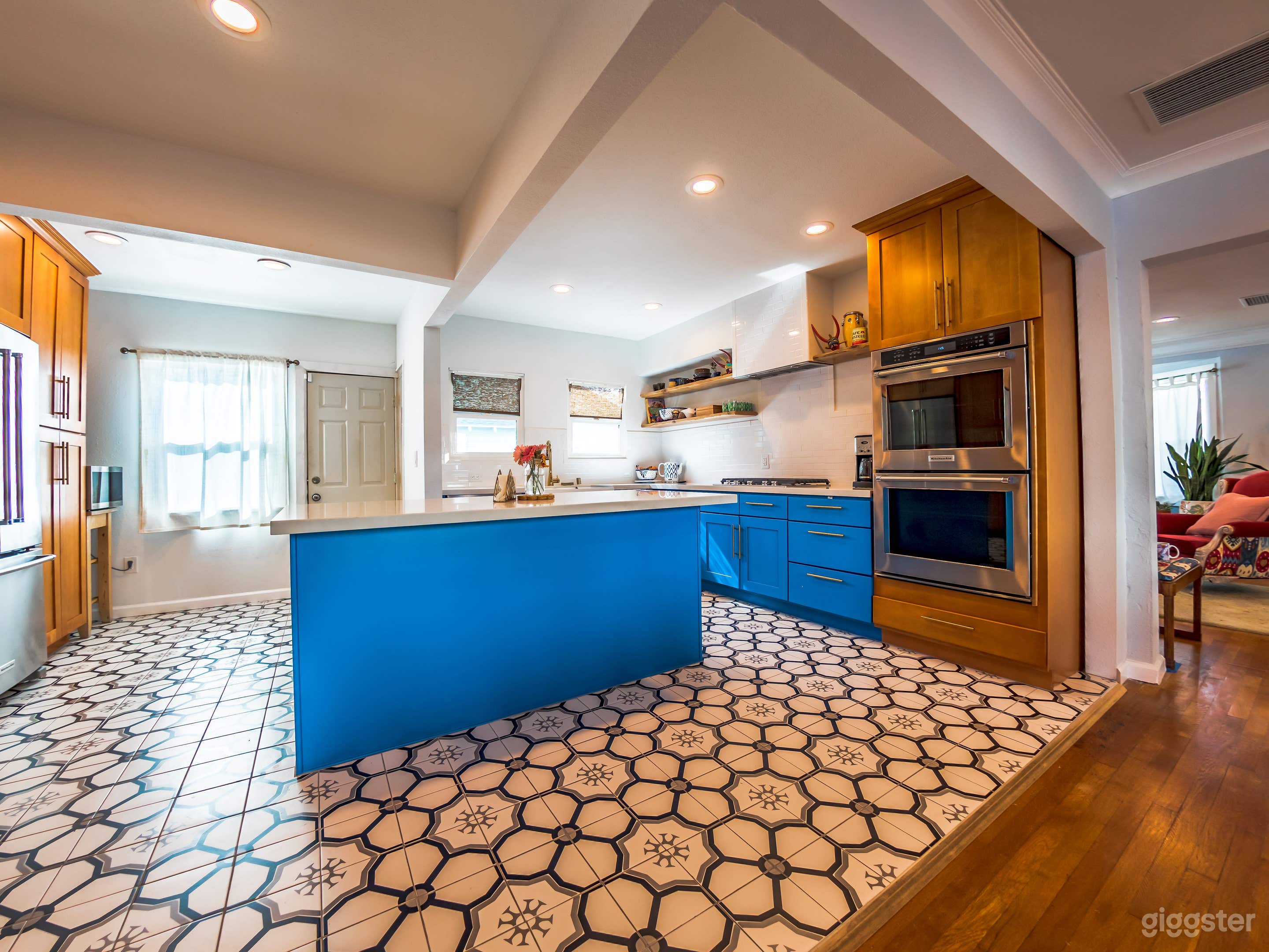 Kitchen is open and features a double oven. 