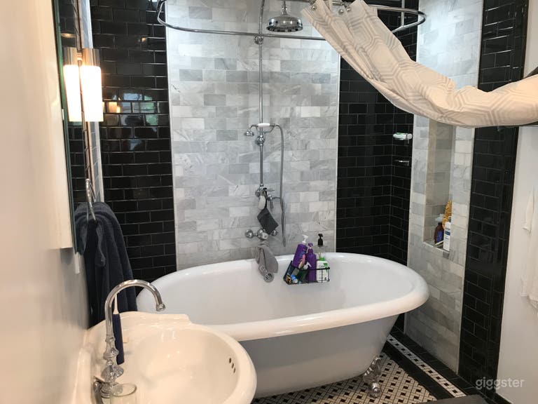  You’ve likely never seen a bigger claw foot tub. Double pedestal Sinks too. Tile bathroom 