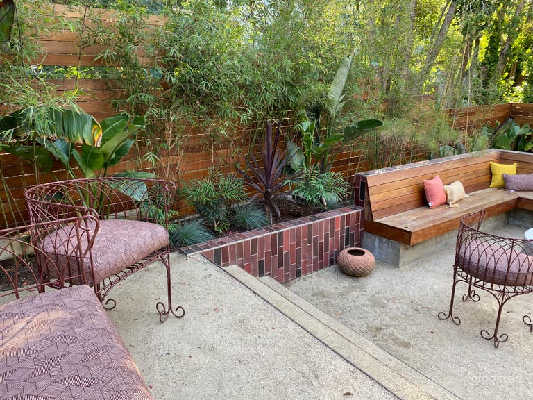  Unique, colorful backyard with terraced spaces, Heath tile, lush tropical plants, fire pit.  