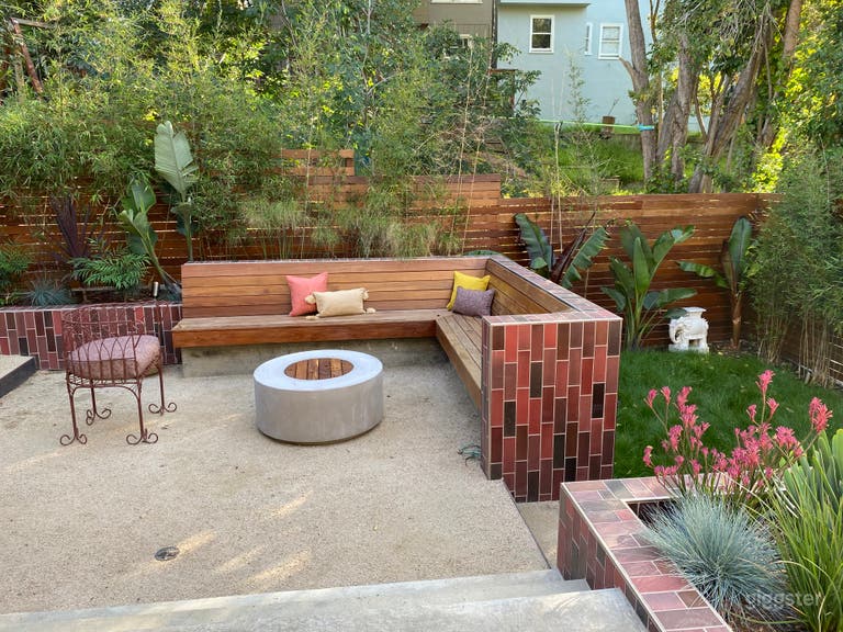  Unique, colorful backyard with terraced spaces, Heath tile, lush tropical plants, fire pit.  