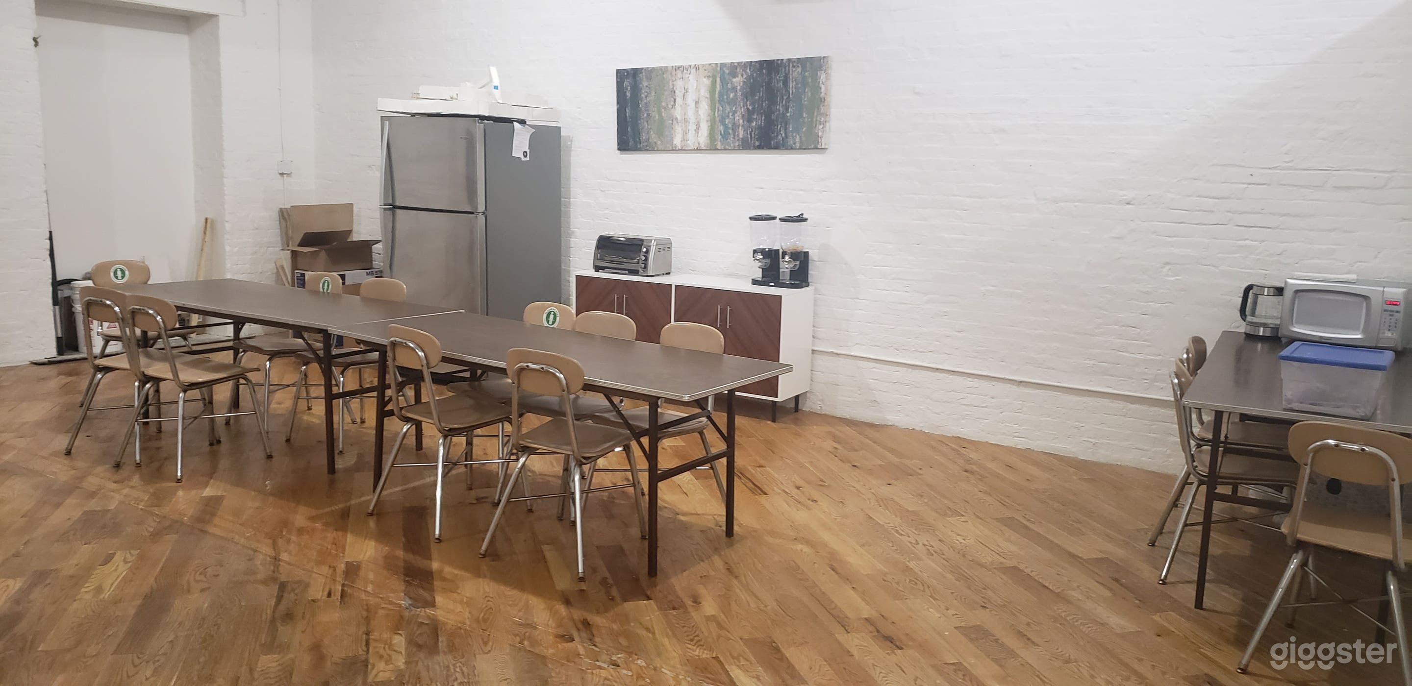 Kitchen with refrigerator, stove top and microwave.