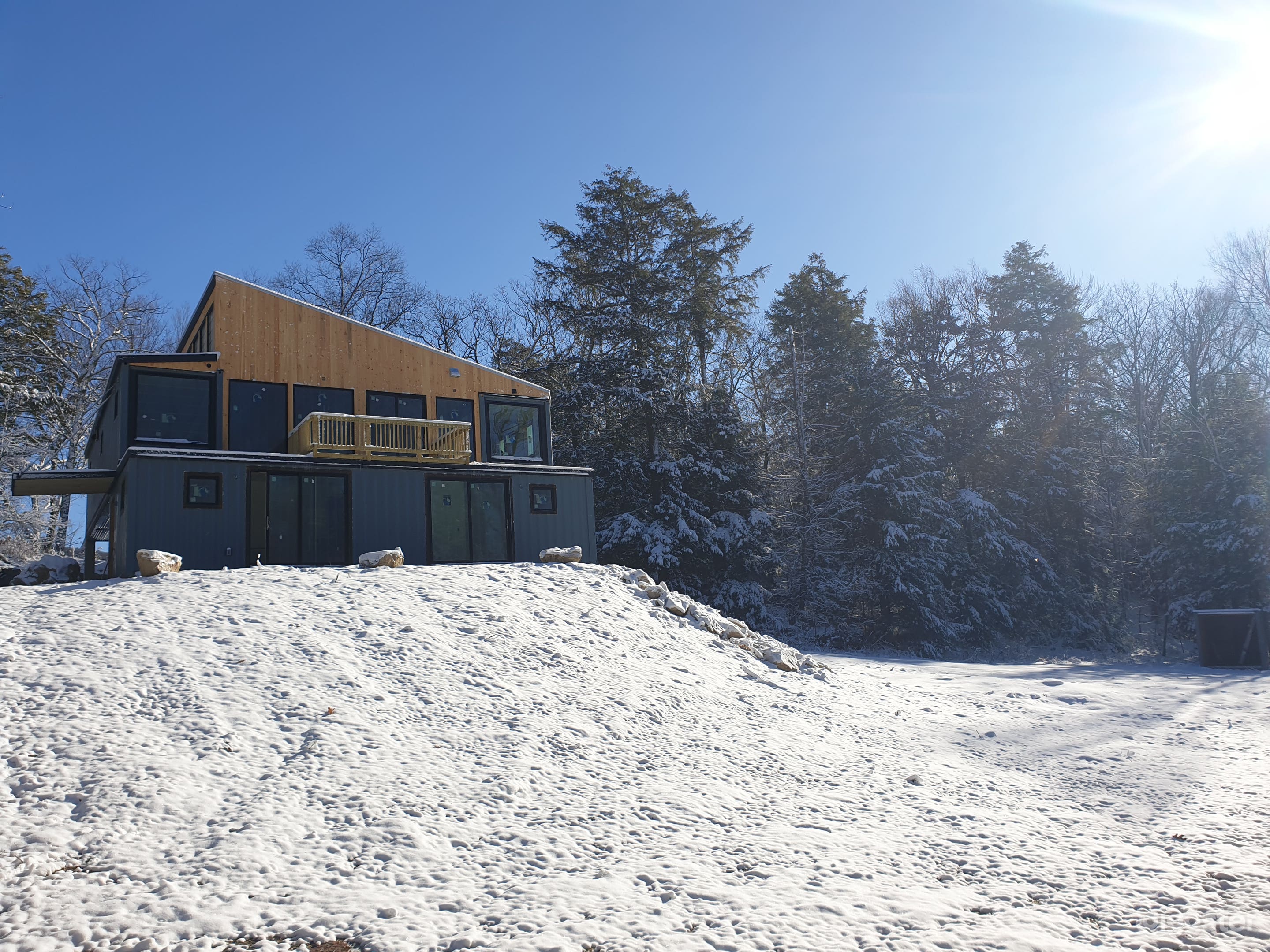 Front deck, entryway, lower in-law suite, and 1/5 of acreage.