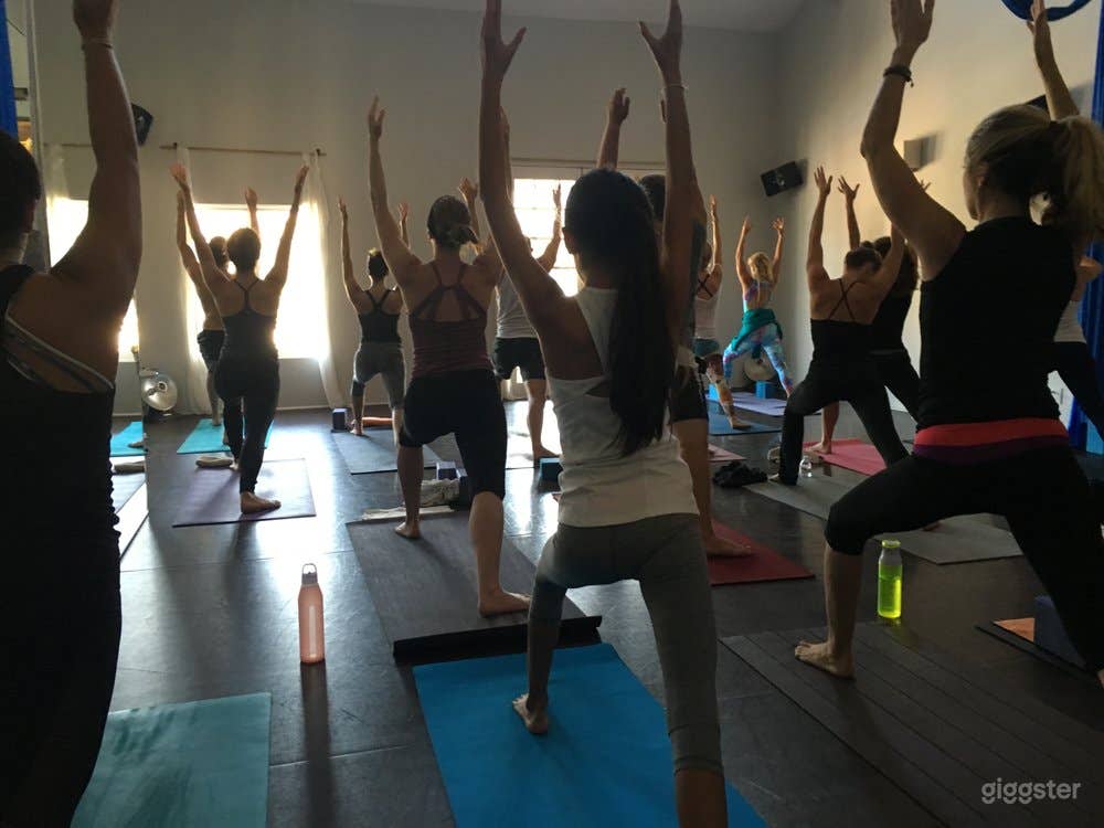 yoga class in session looking from studio door to the back door/balcony.
