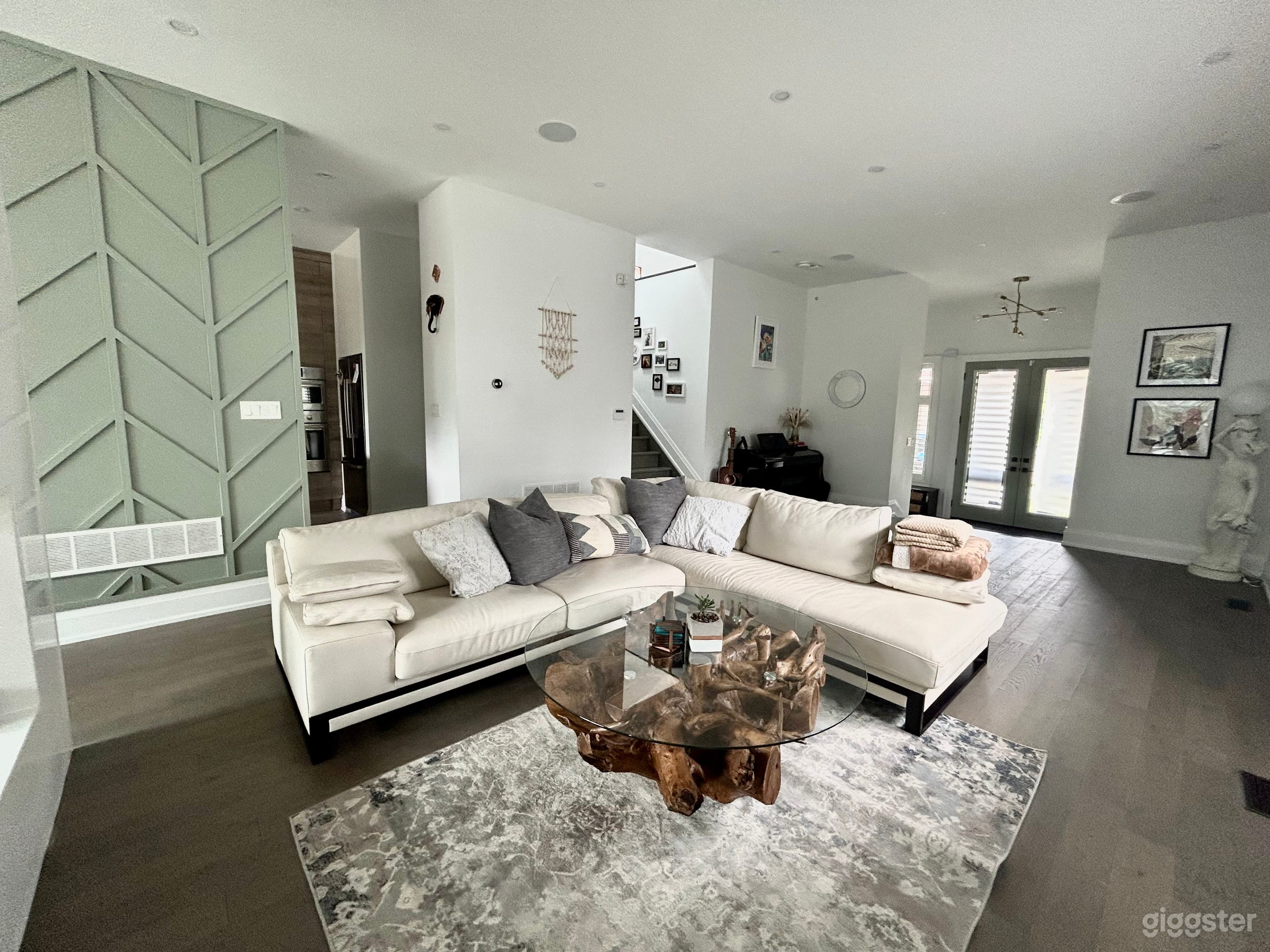Spacious, bright, modern living room with nature based palette. Galeleio piano and statue imported from Italy, one of a kind coffee table custom made from Sri Lanka.
