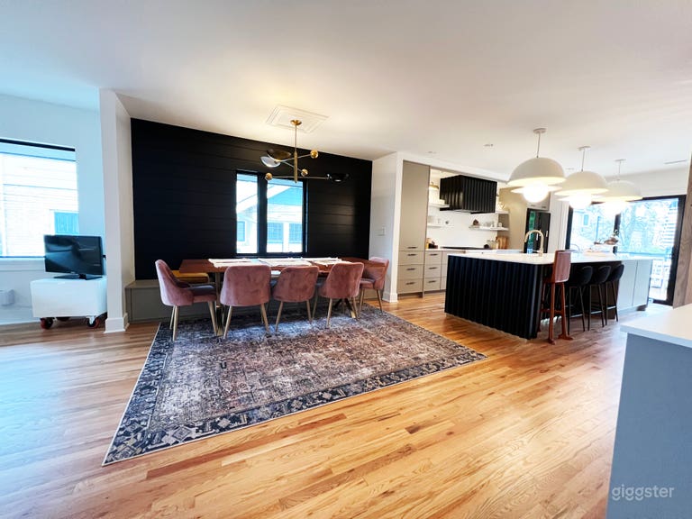  Black ship lap wall wall treatment in the dinning room with pink velvet chairs and retro vintage lighting 