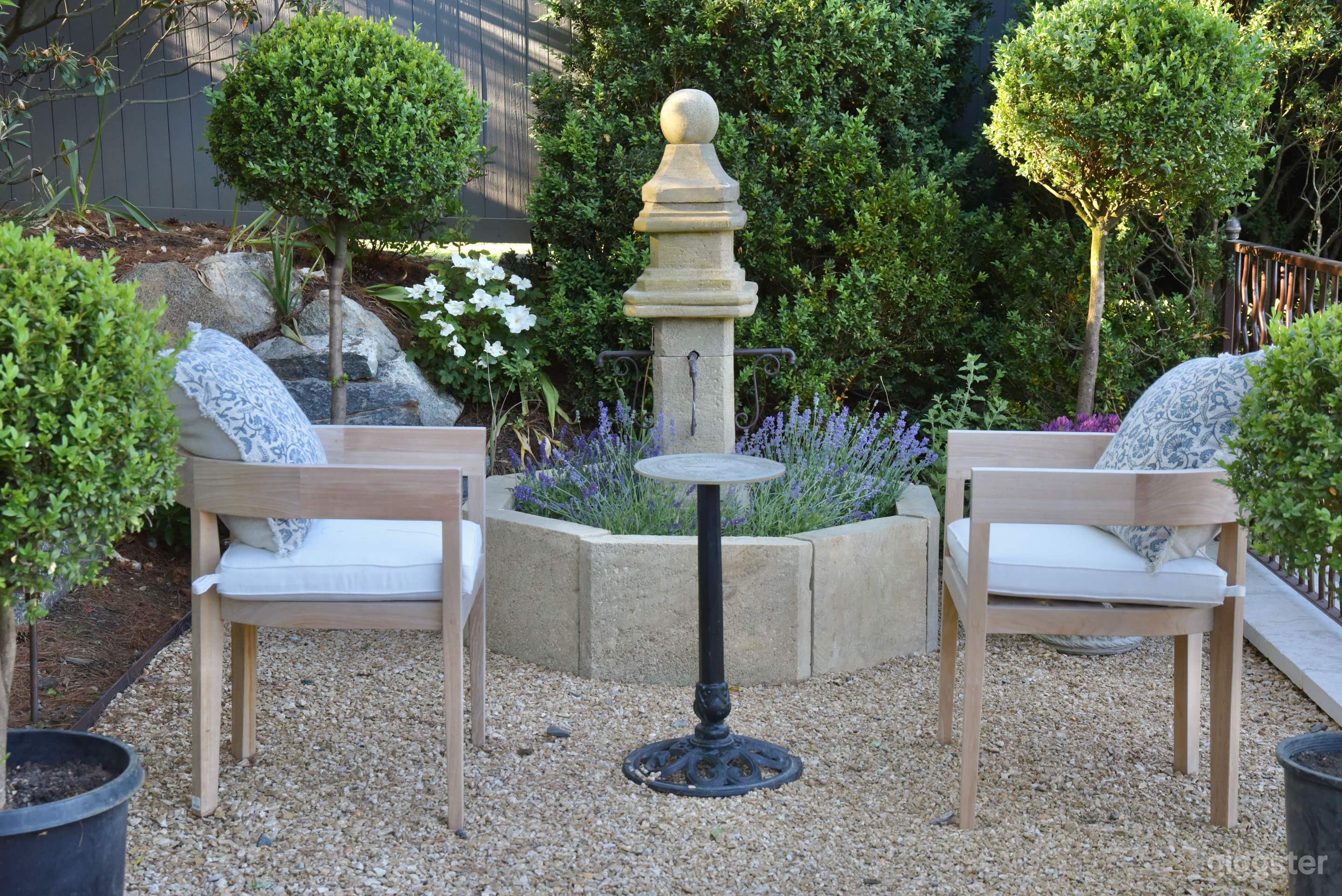 Elegant Garden Patio with Umbrellas & Greenery Photo 3