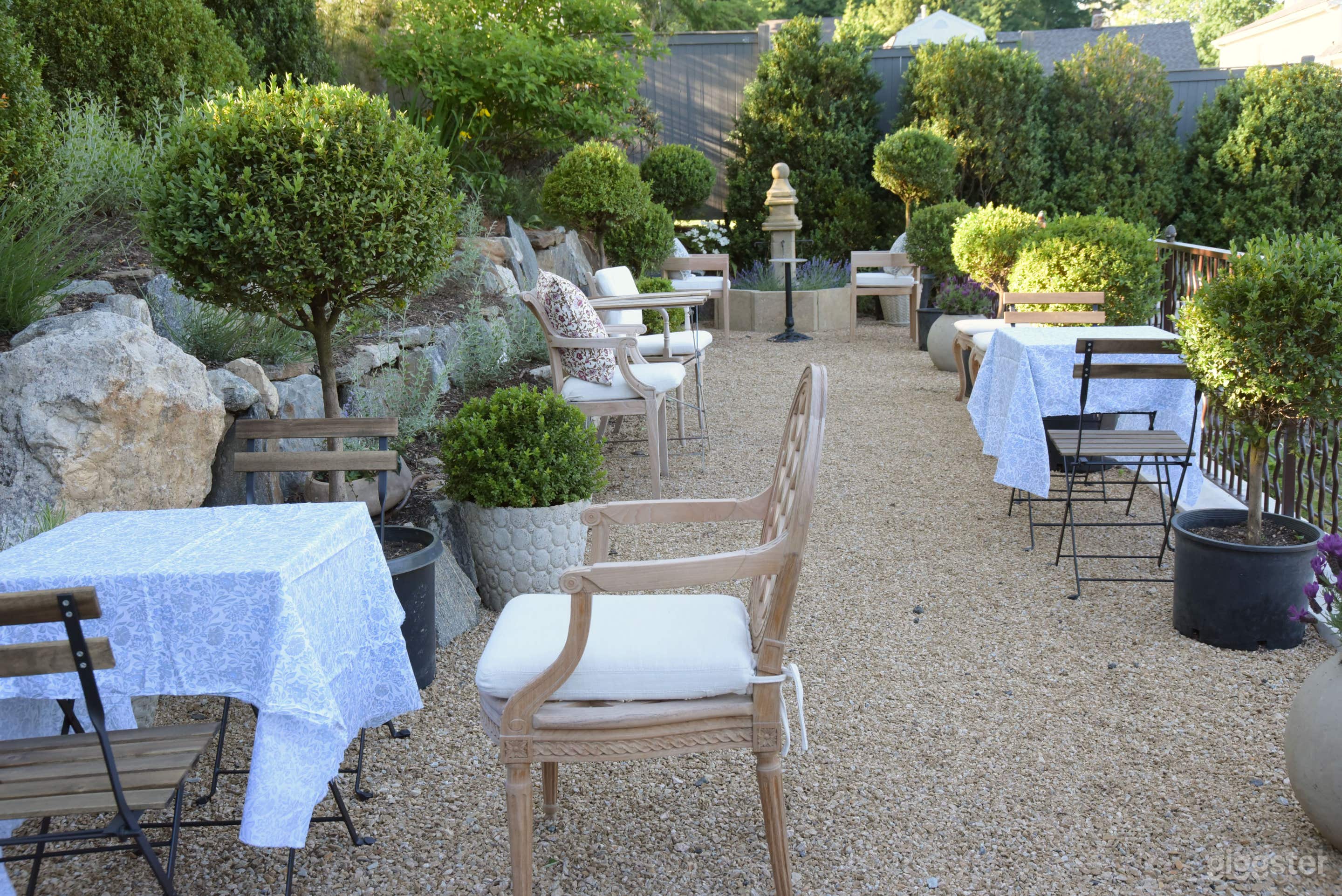 Elegant Garden Patio with Umbrellas & Greenery Photo 4