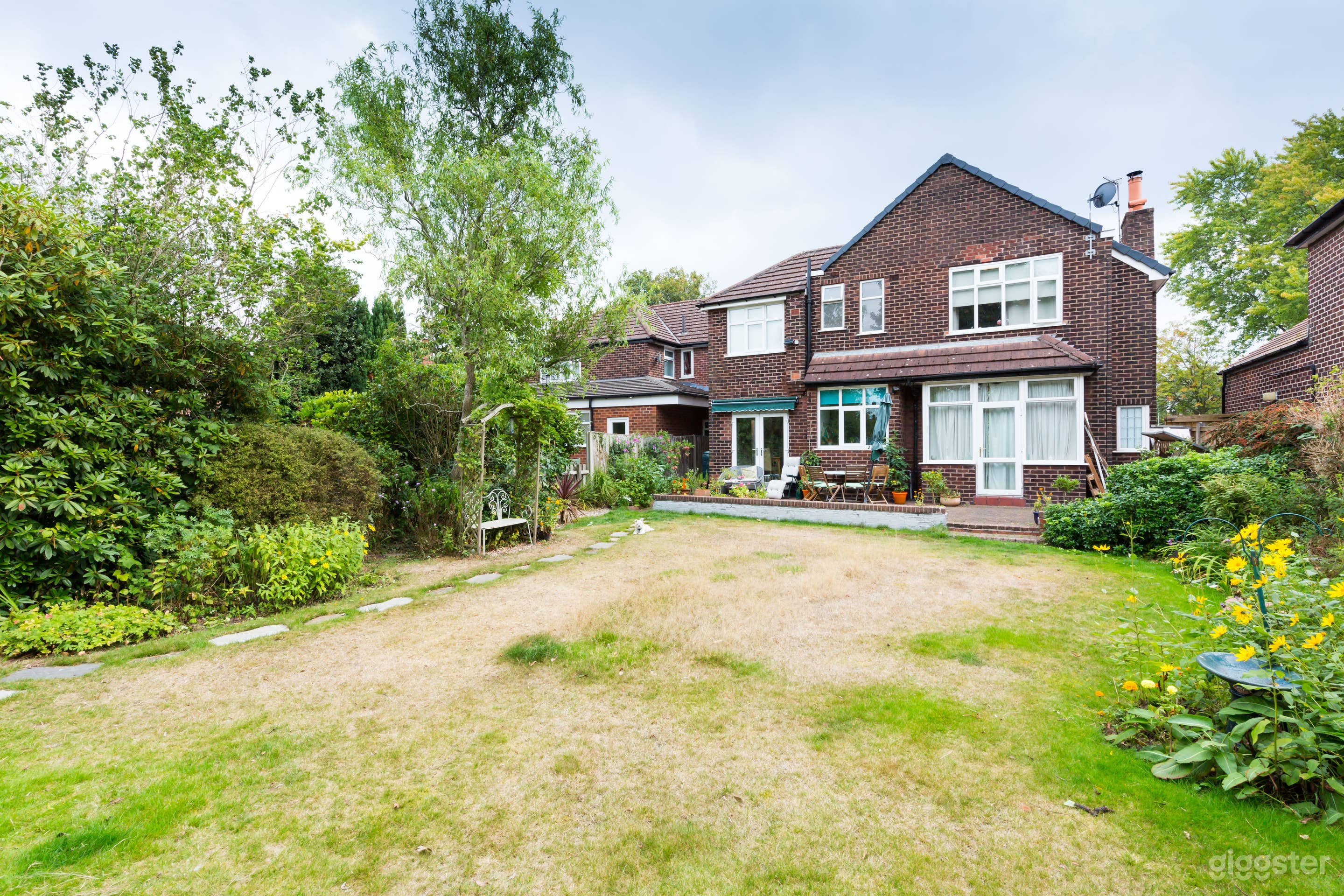 Back view of house (the grass is usually green but we have had a drought recently)