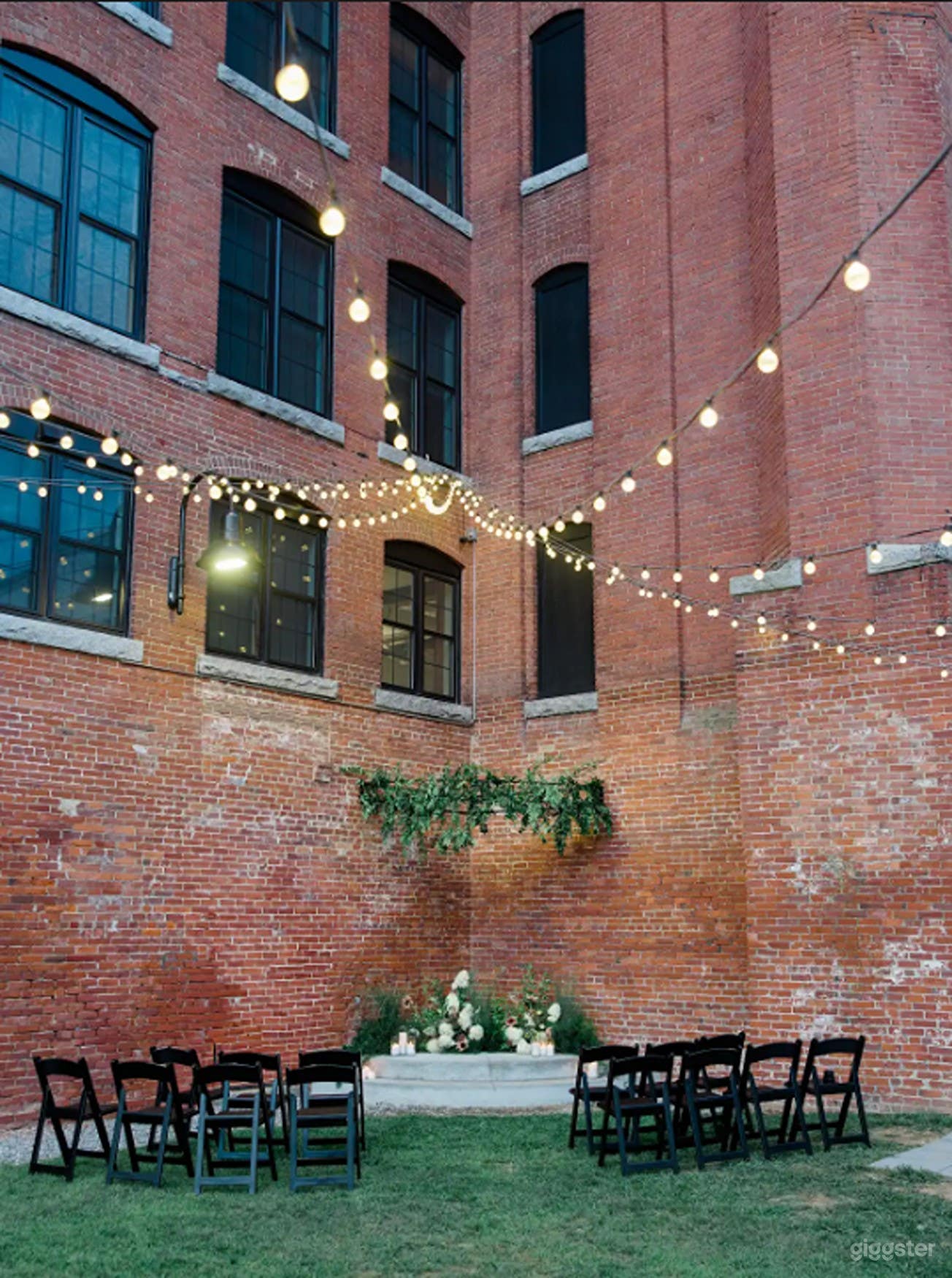 Urban Upper Courtyard with Bistro Lights & Red Brick Charm Photo 1