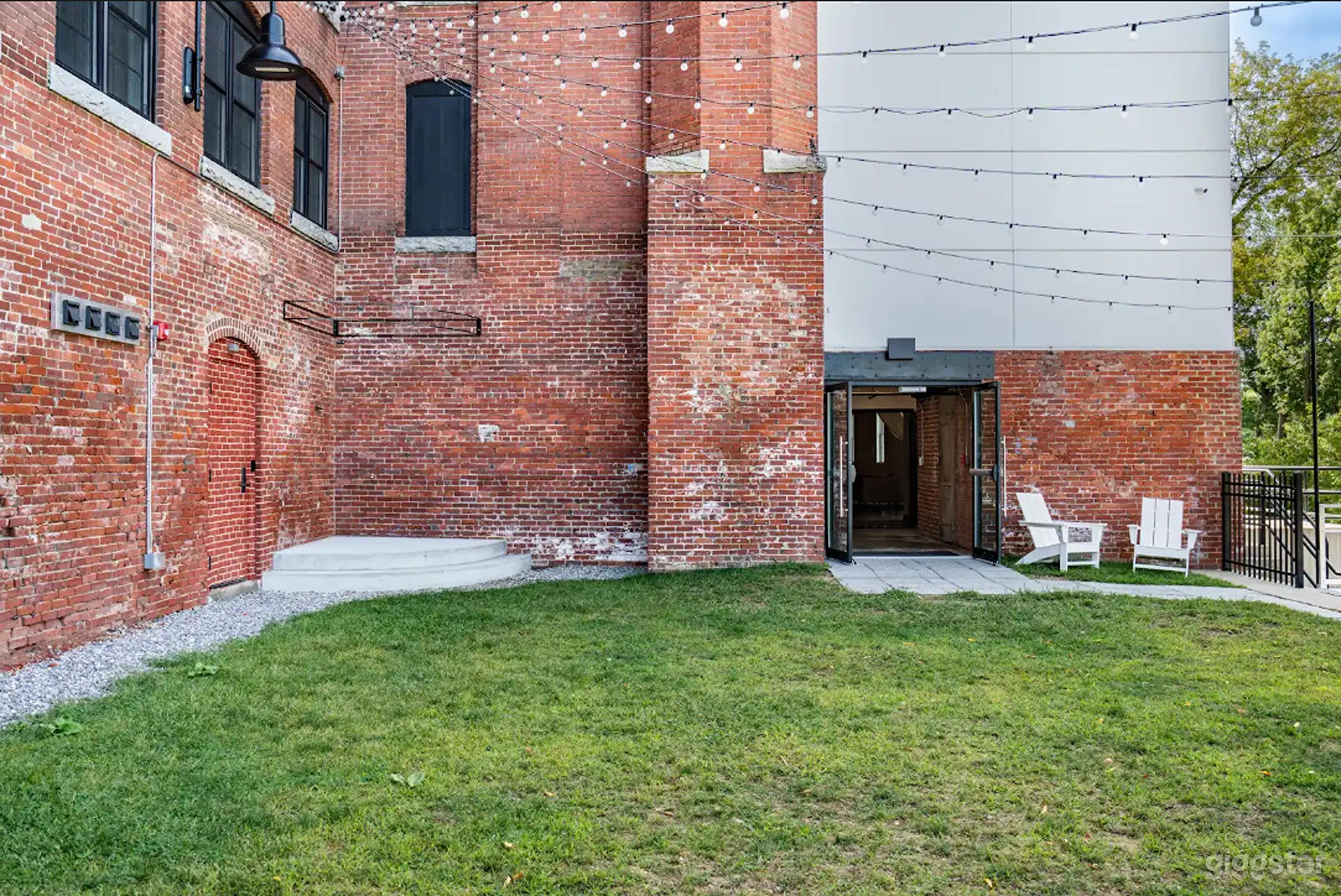 Urban Upper Courtyard with Bistro Lights & Red Brick Charm Photo 2